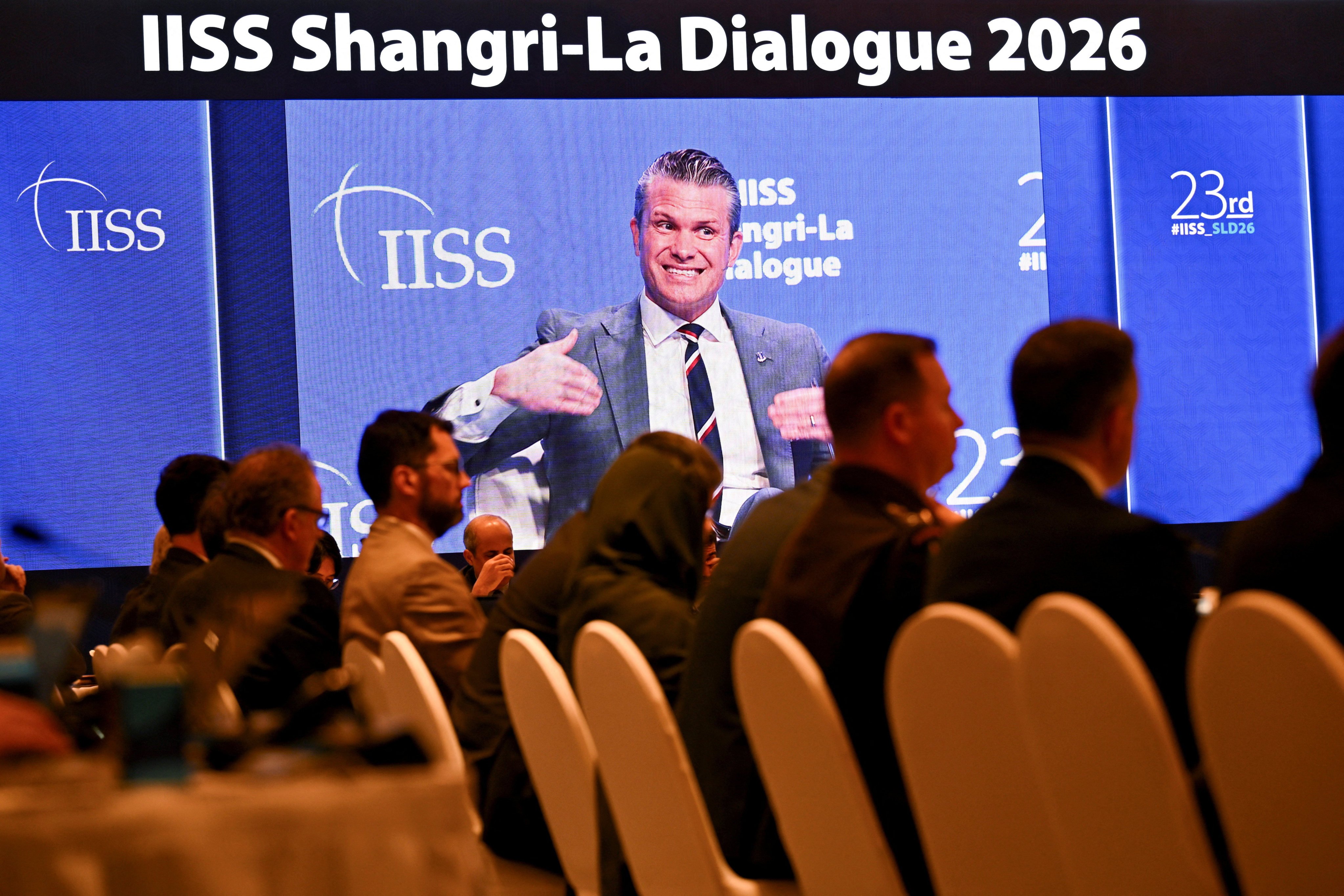 Delegates watch US Defence Secretary Pete Hegseth’s speech on a screen at the Shangri-La Dialogue security summit in Singapore on Saturday. Photo: Reuters