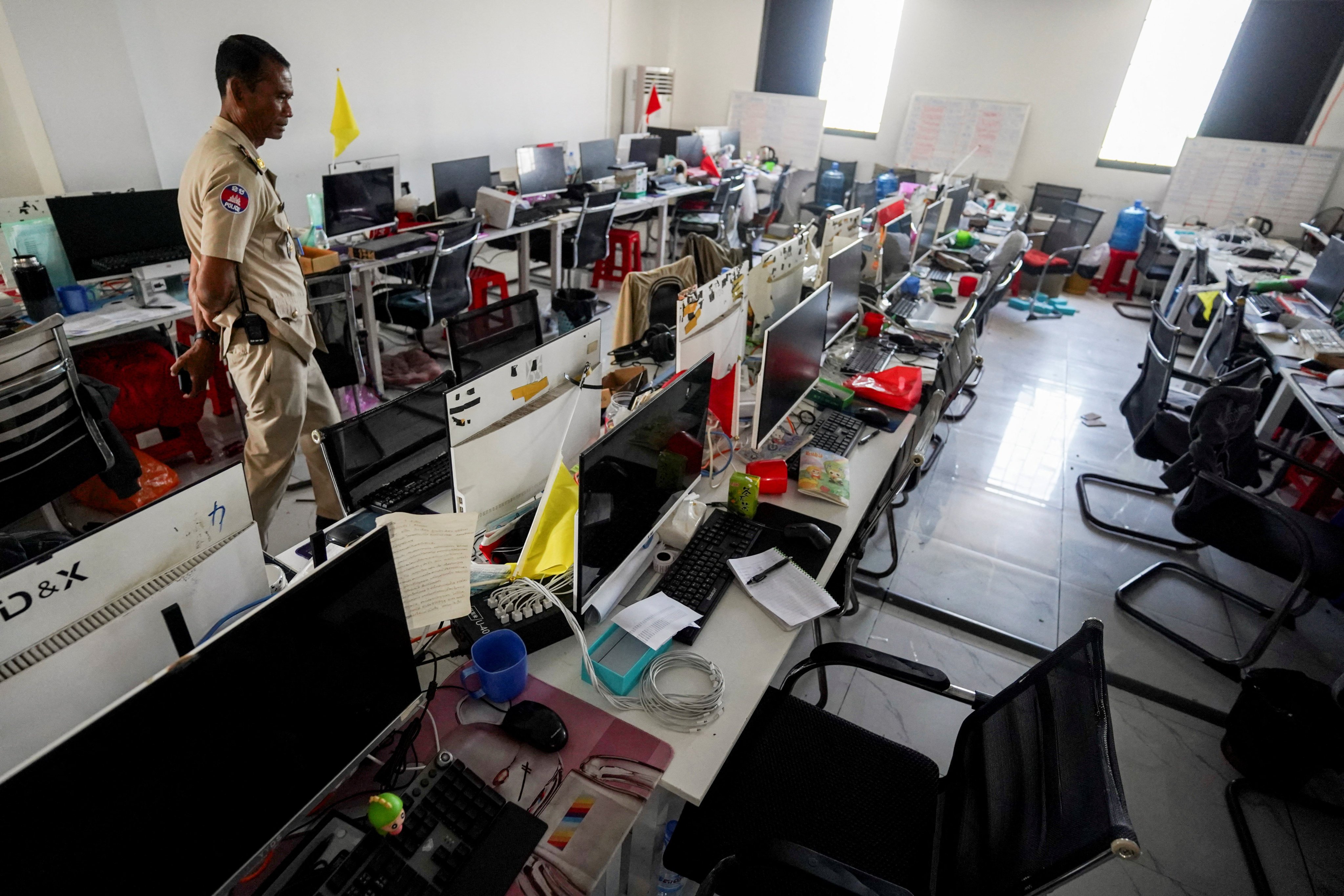 A police officer inspects a scam compound in Cambodia’s Kampot province in February. Photo: Reuters