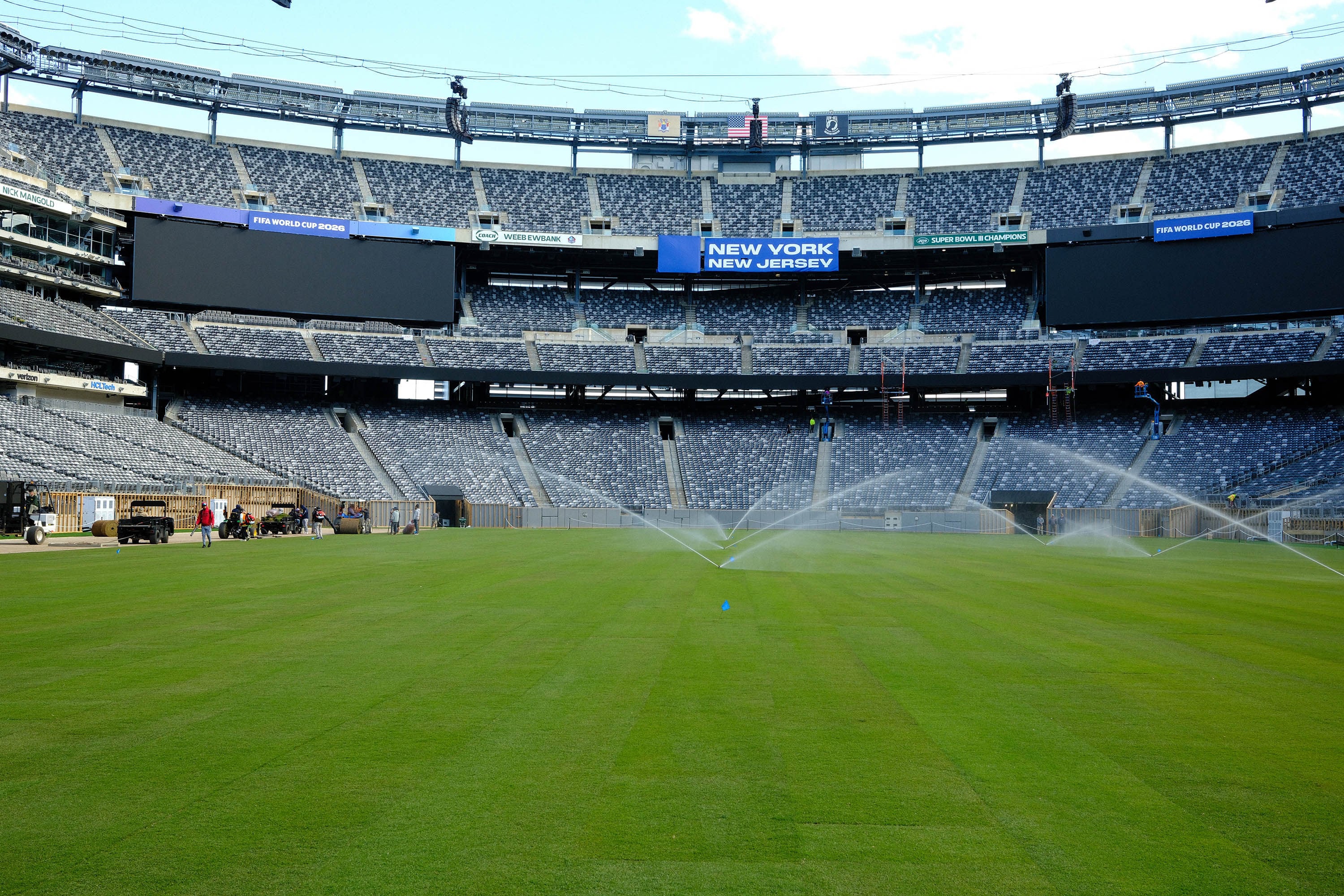 Workers water the newly installed pitch at MetLife Stadium ahead of the 2026 FIFA World Cup, in East Rutherford, New Jersey. Photo: Getty Images