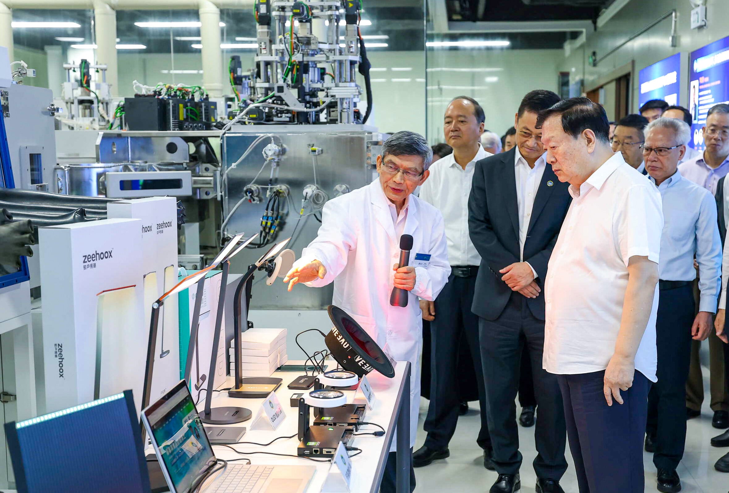 Xia Baolong is accompanied by Macau Chief Executive Sam Hou Fai as he inspects a laboratory. Photo: handout