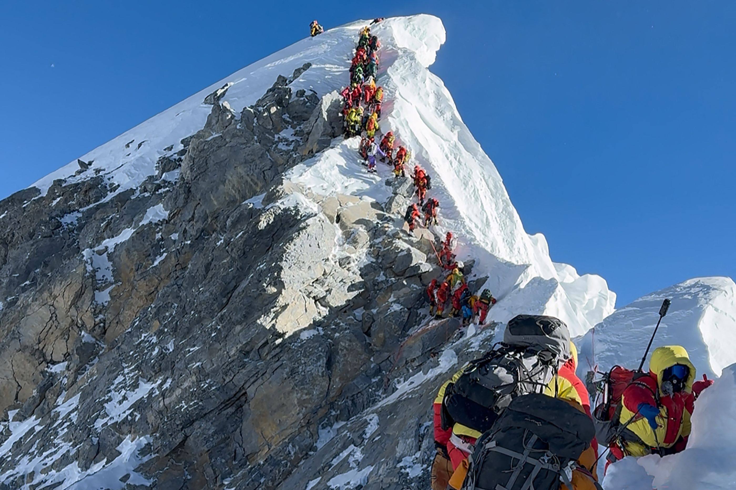 Mountaineers climbing a slope line up during their ascent from the Hillary Step to summit Mount Everest in Nepal last month. Photo: AFP