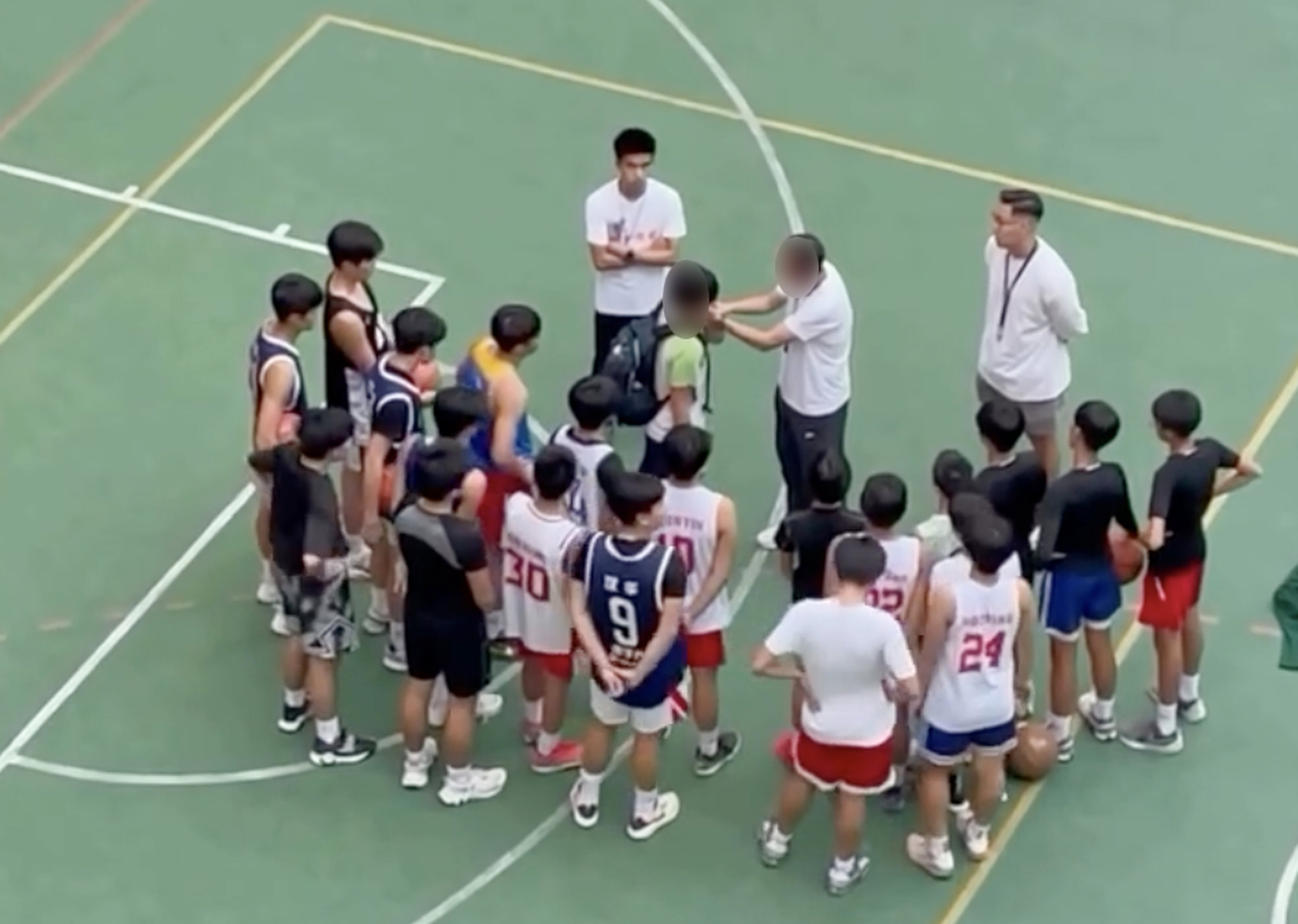 A still from a video in which basketball coach Yung Kam-wah is seen forcing a player to slap himself on the face as a punishment during a training at a secondary school. Photo: Handout