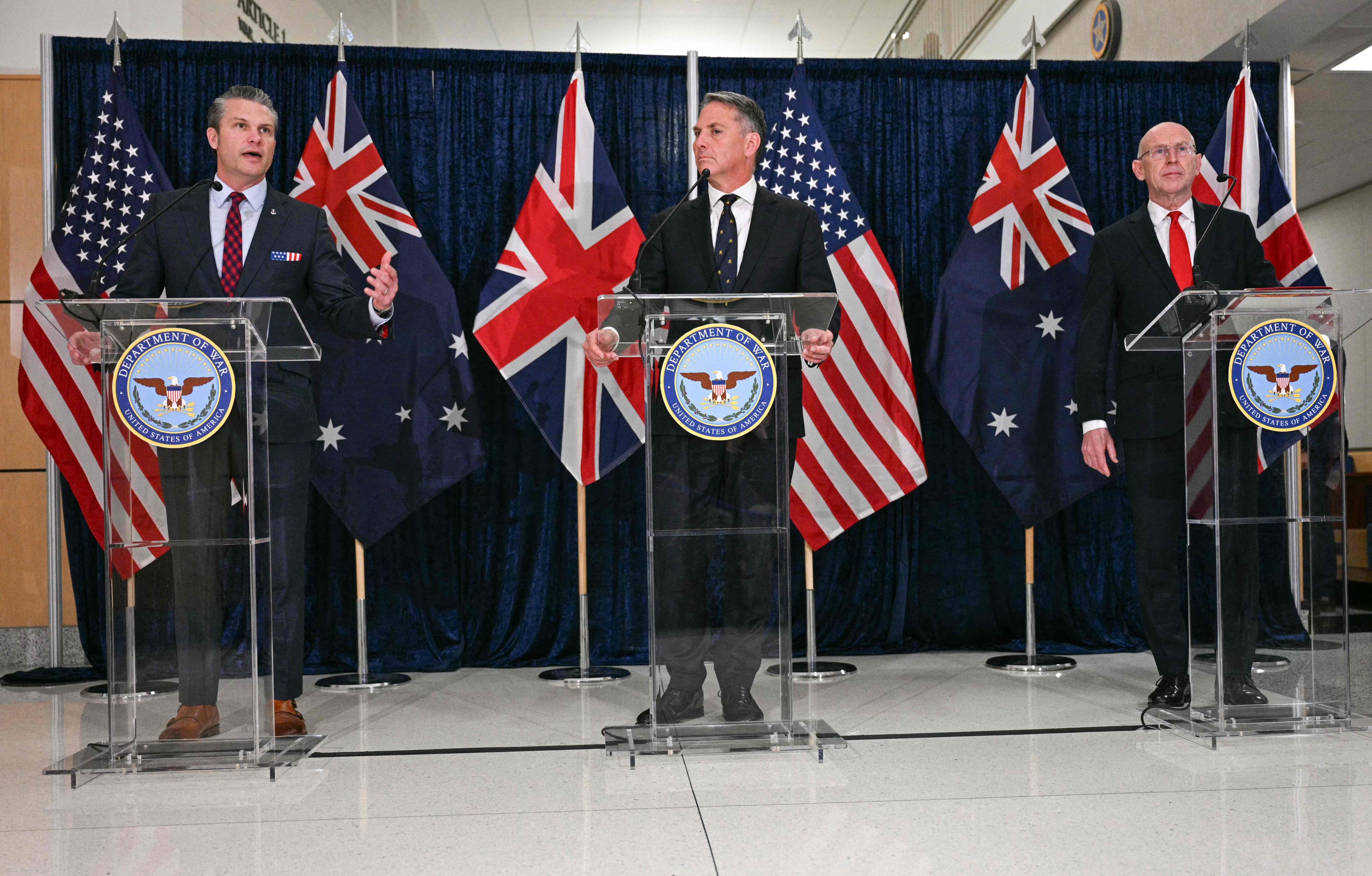 US Secretary of Defence Pete Hegseth speaks as Australian Deputy Prime Minister and Defence Minister Richard Marles and British Defence Secretary John Healey look on during the Aukus meeting at the Pentagon in Washington, on December 10, 2025. Photo: AFP