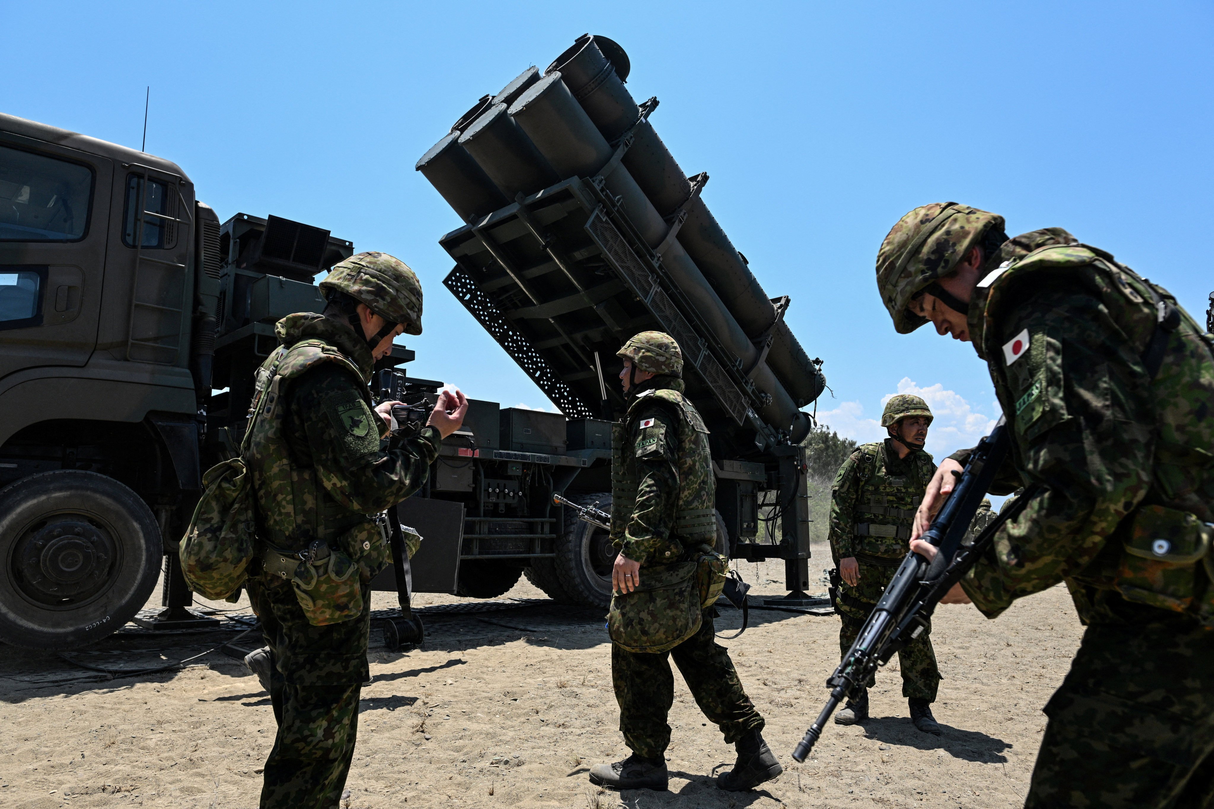 Japan Ground Self-Defence Force soldiers walk in front of a Type 88 surface-to-ship missile launcher during military drills in the Philippines on May 6. Photo: Reuters