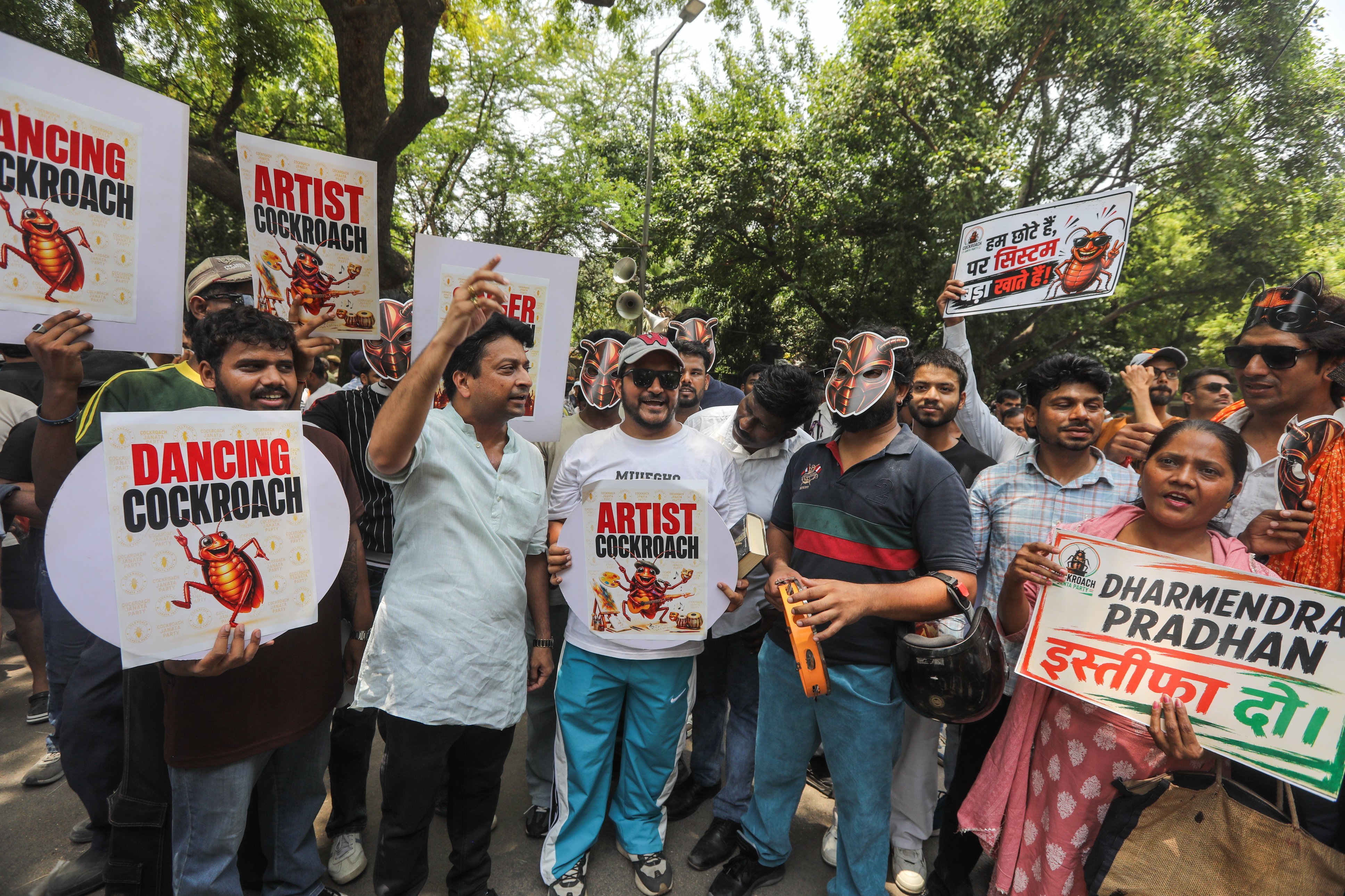 Supporters of the satirical youth movement Cockroach Janta Party hold placards during a protest in New Delhi, India, on Saturday. Photo: EPA