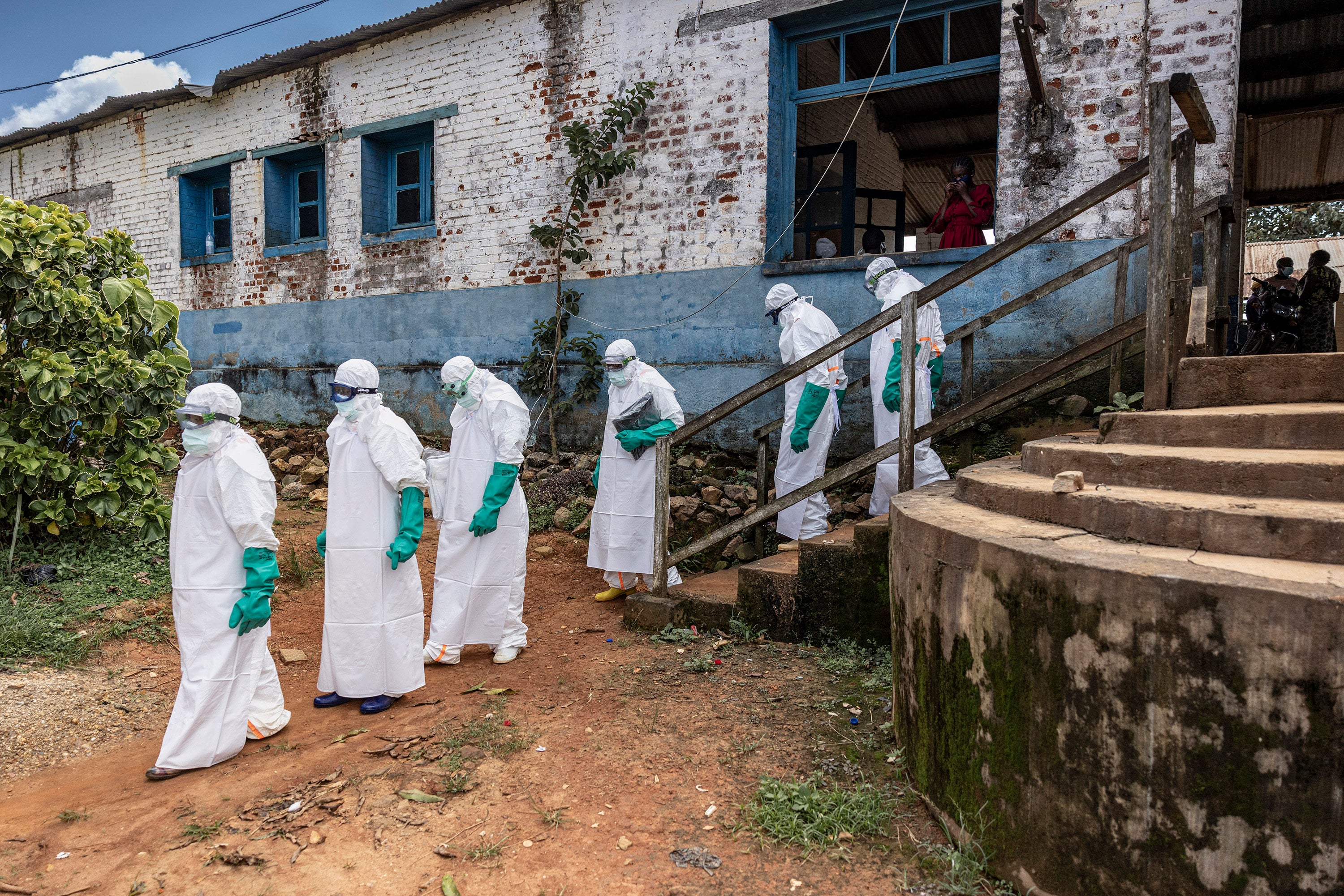 Health workers wearing protective equipment walk outside the General Referral Hospital during the Ebola outbreak response on May 21, in Mongbwalu, Democratic Republic of Congo. Photo: TNS