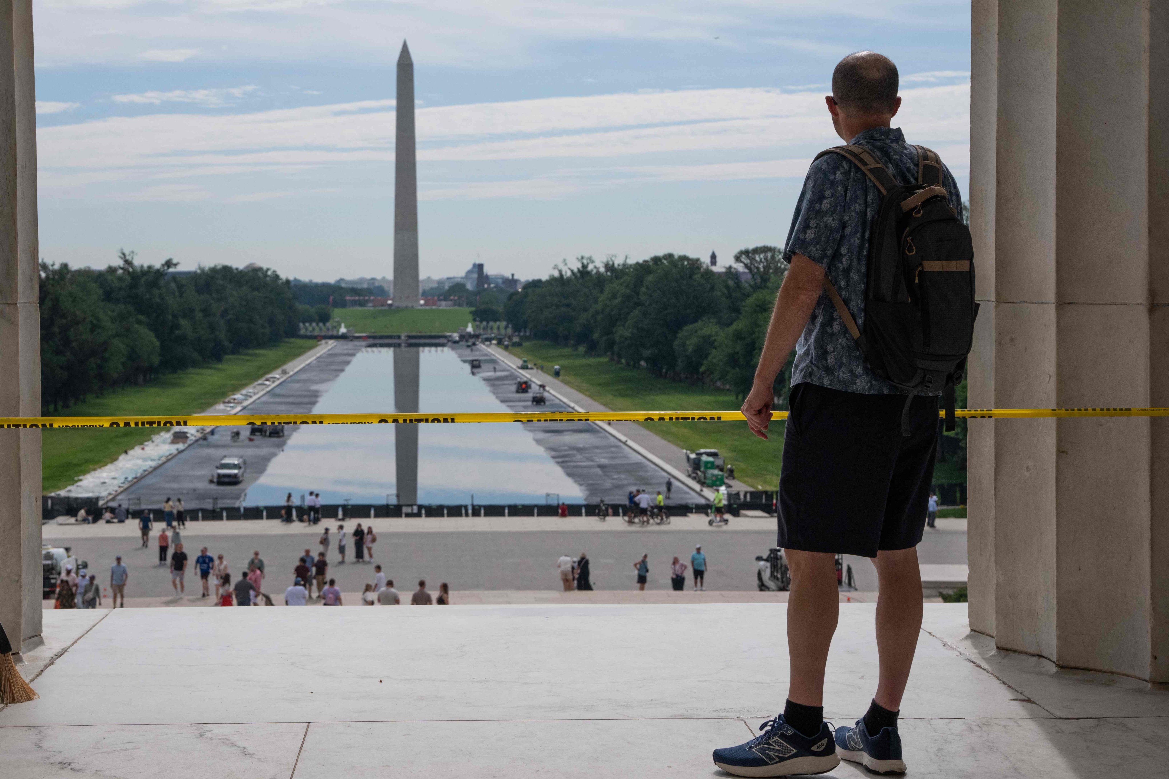 People walk past the Reflecting Pool on the National Mall on June 6, in Washington, as the Trump administration has repaints and cleans it ahead of the country’s 250th anniversary next month. Photo: Getty Images via AFP