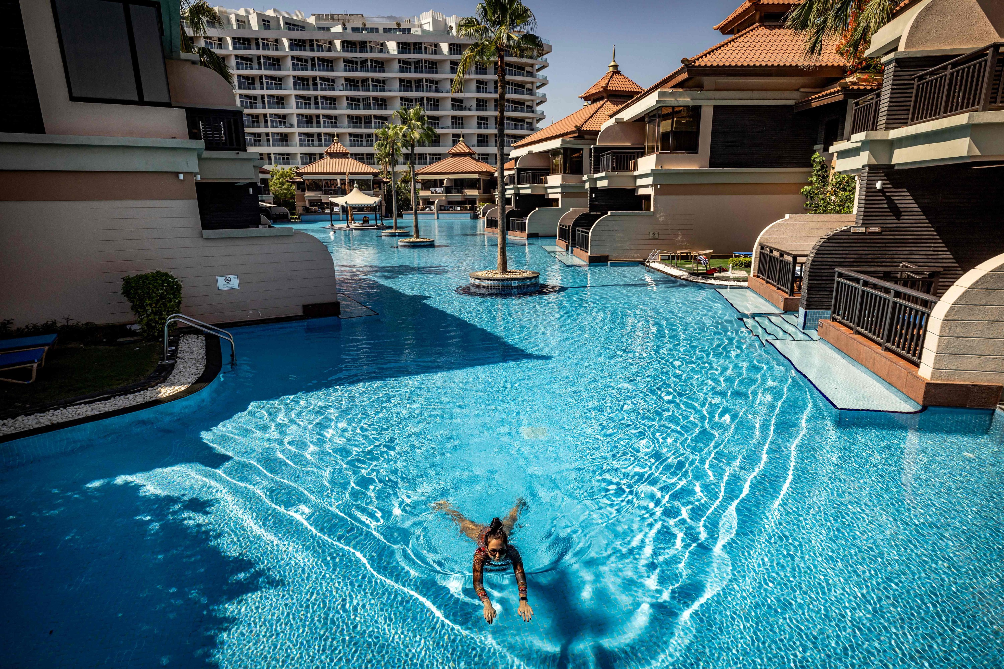 A woman swims in a pool at the Anantara The Palm Dubai Resort in the UAE on Saturday. Photo: AFP