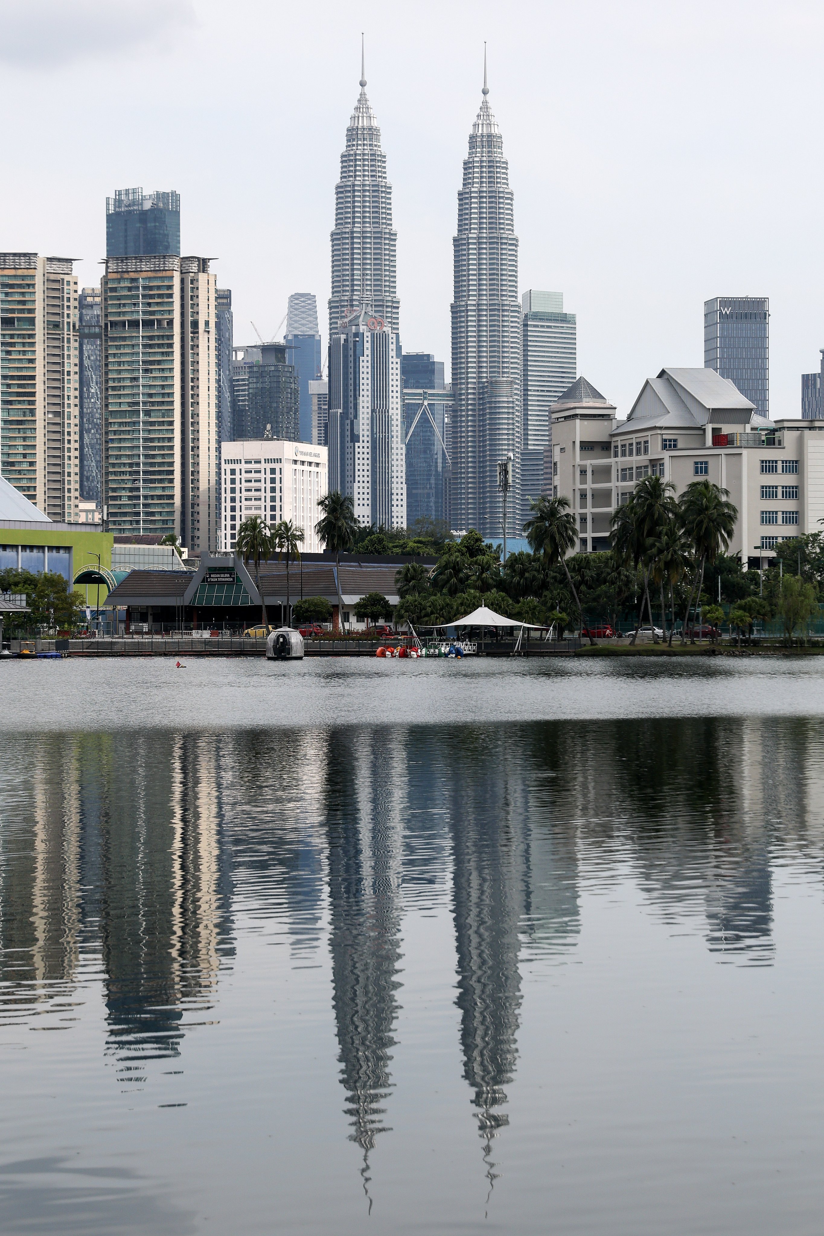 Malaysia’s iconic Petronas Twin Towers in Kuala Lumpur. The country has announced a crackdown against illegal businesses run by foreigners. Photo: EPA