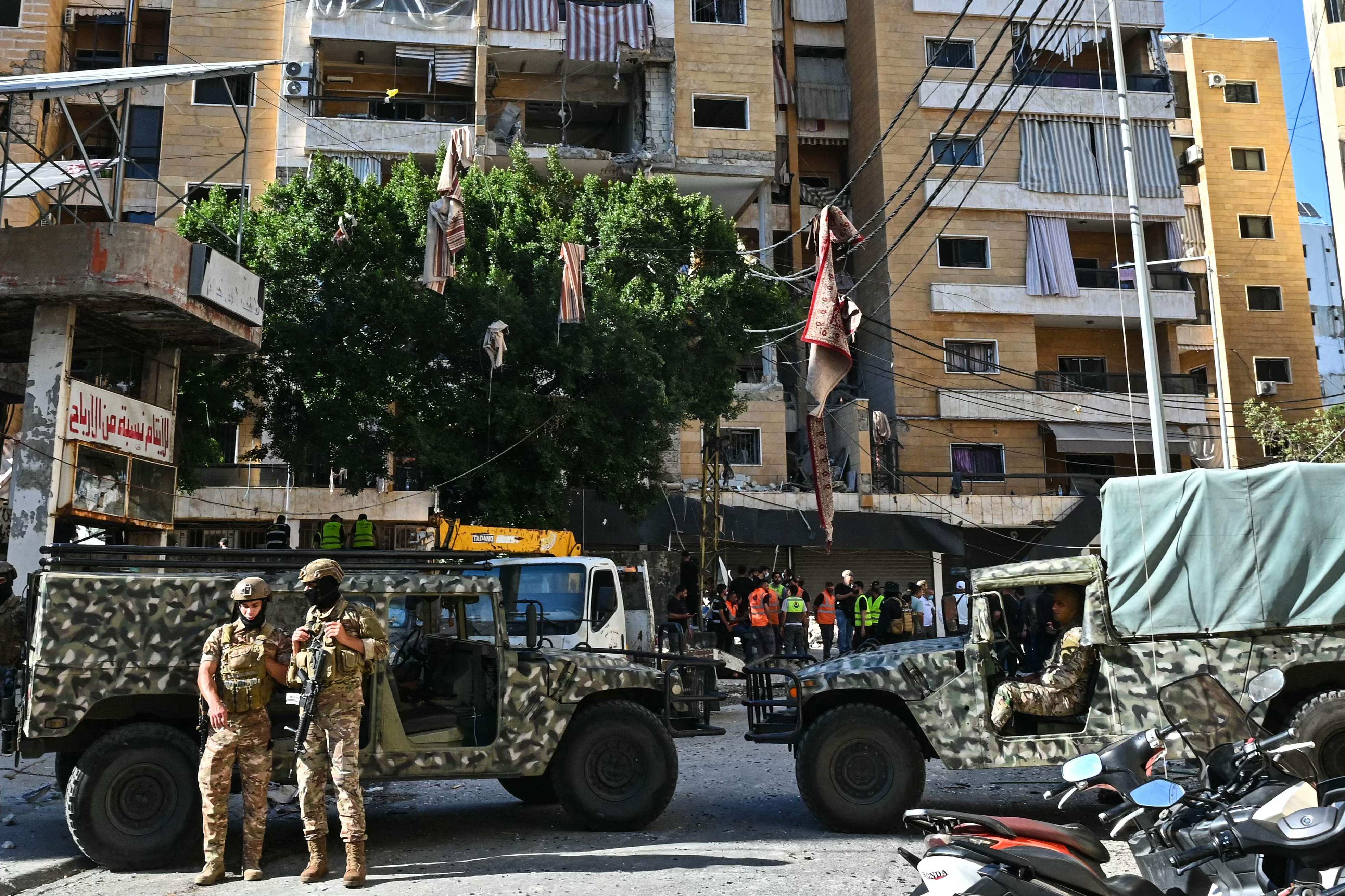 Lebanese soldiers stand guard as first responders inspect damage at the site of an Israeli air strike targeting a residential building in Beirut’s southern suburbs on Sunday. Photo: AFP