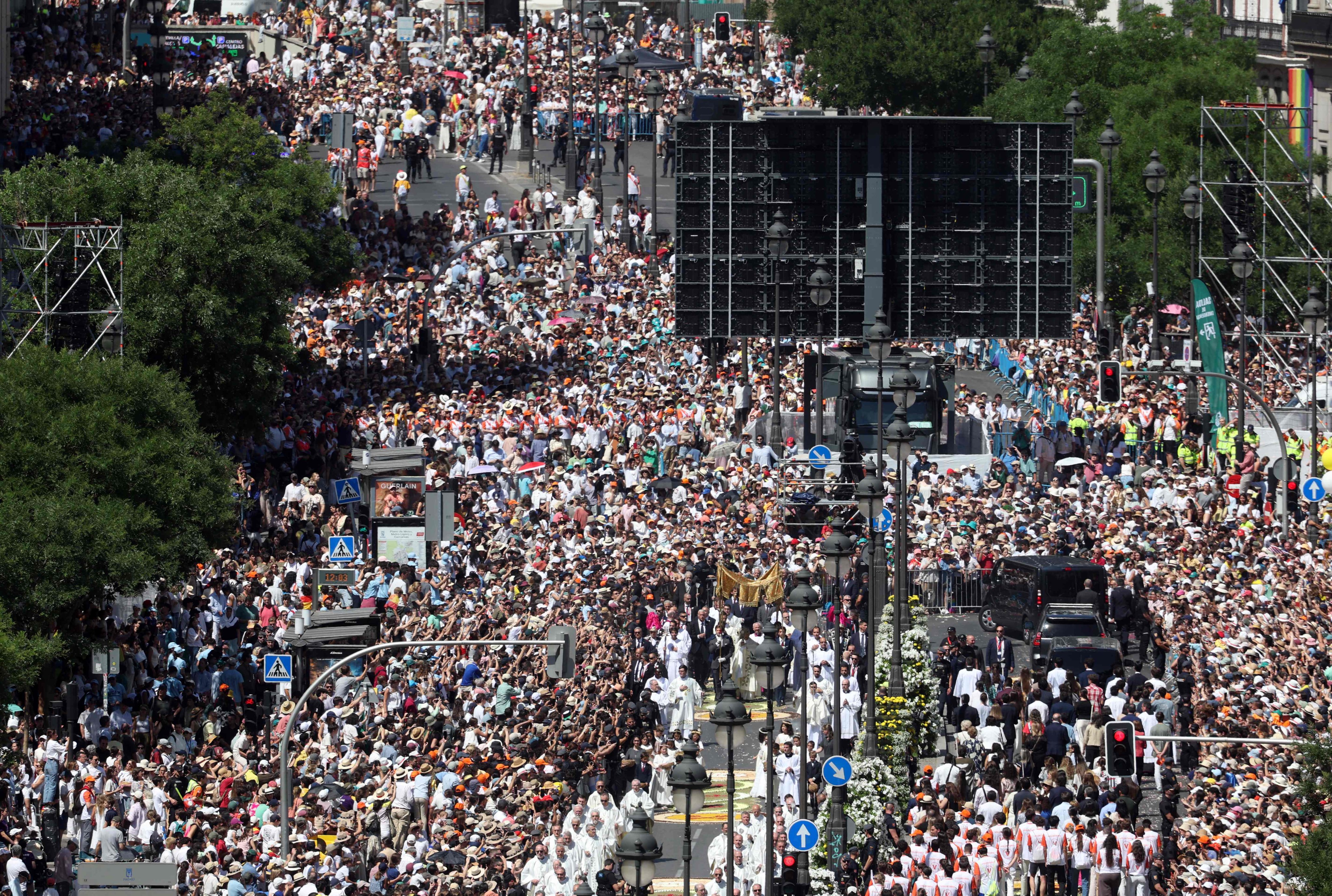 A crowd packs Alcala street as Pope Leo walks under a processional canopy during the Corpus Christi procession following the Mass held in the Plaza de Cibeles in Madrid, Spain on Sunday. Photo: AFP