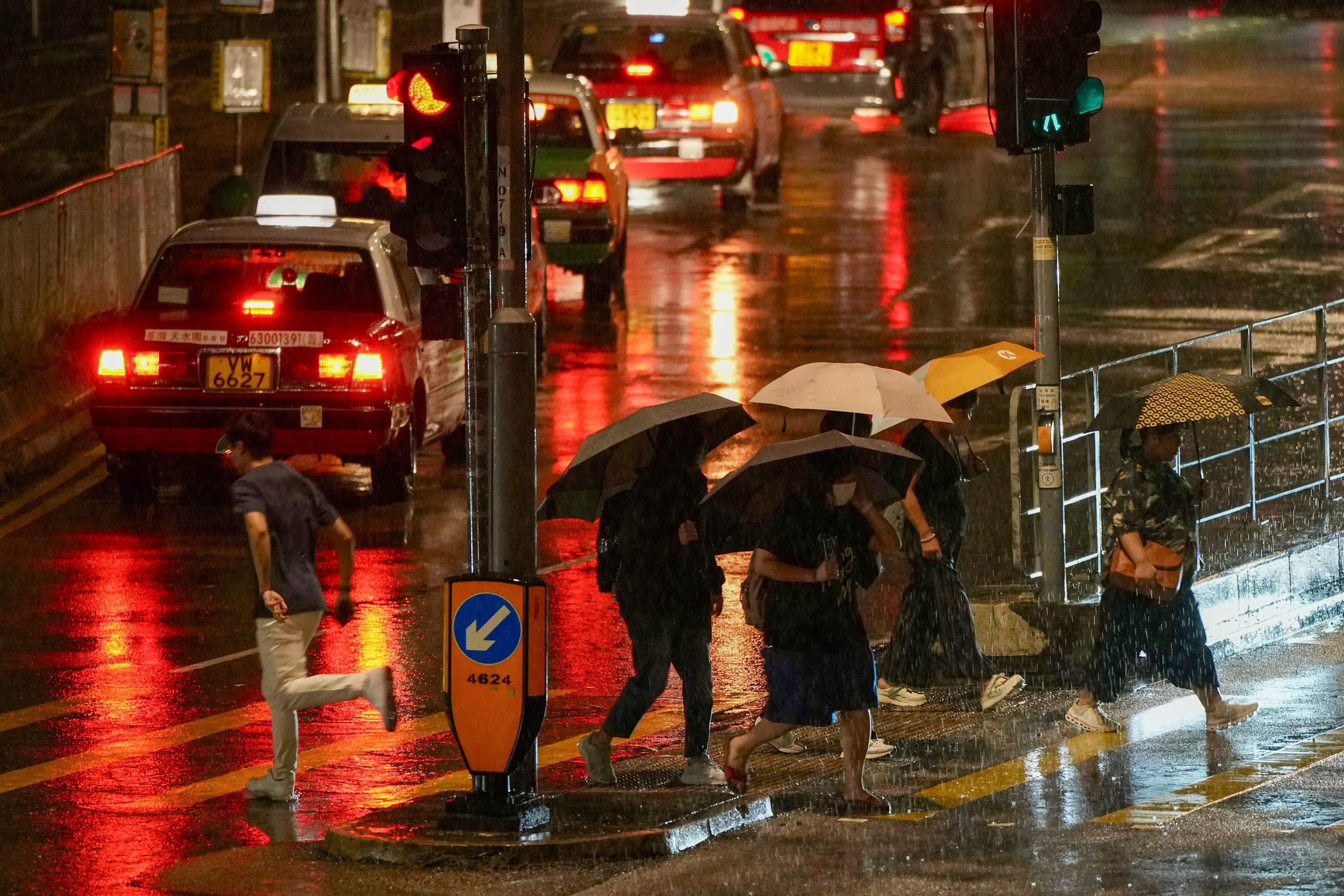 Pedestrians brave the rain in Sha Tin. Photo: Sam Tsang