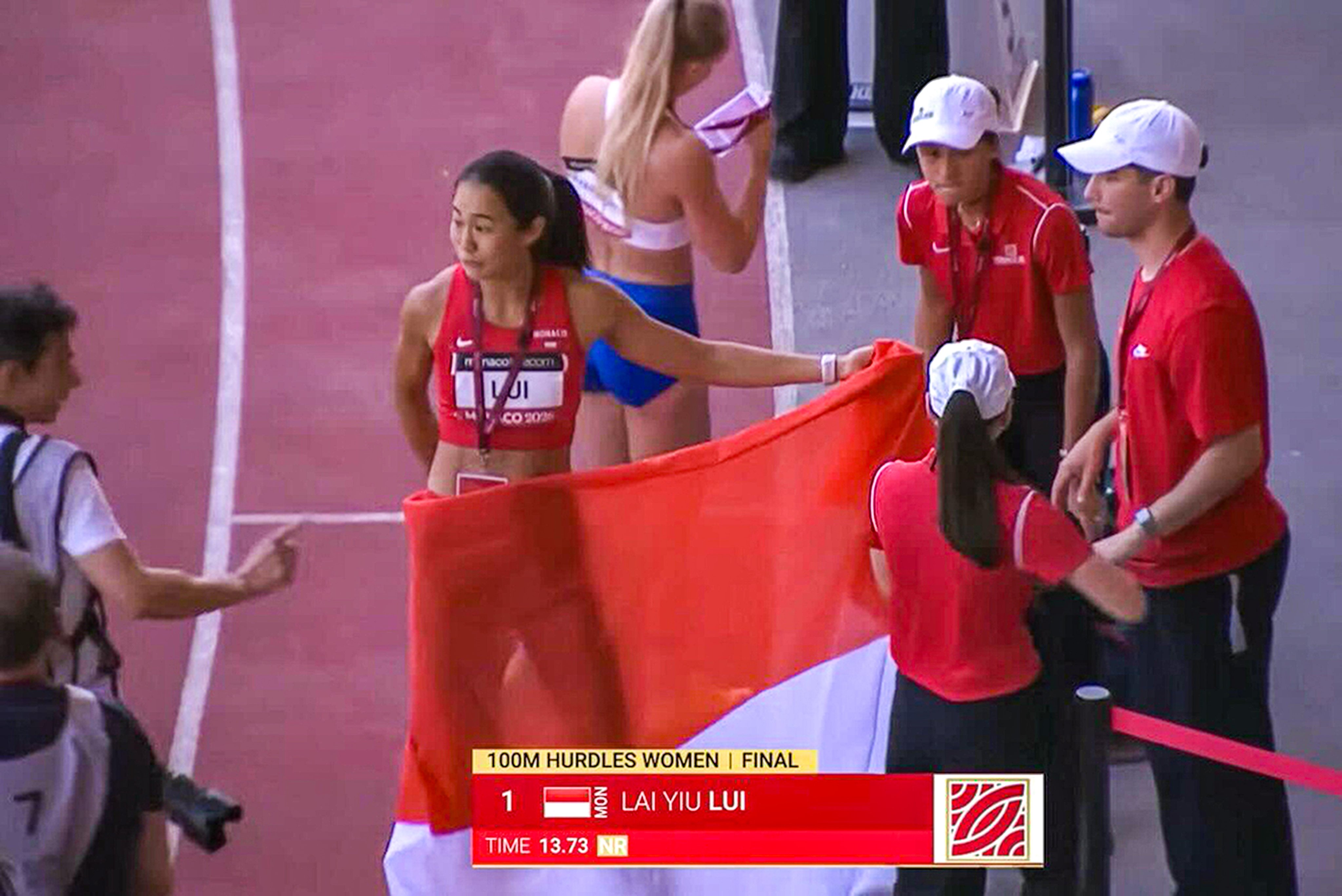 Hong Kong hurdler Vera Lui with a Monaco flag draped around her after winning the 100m hurdles event at the meet in Monaco last month. Photo: Handout