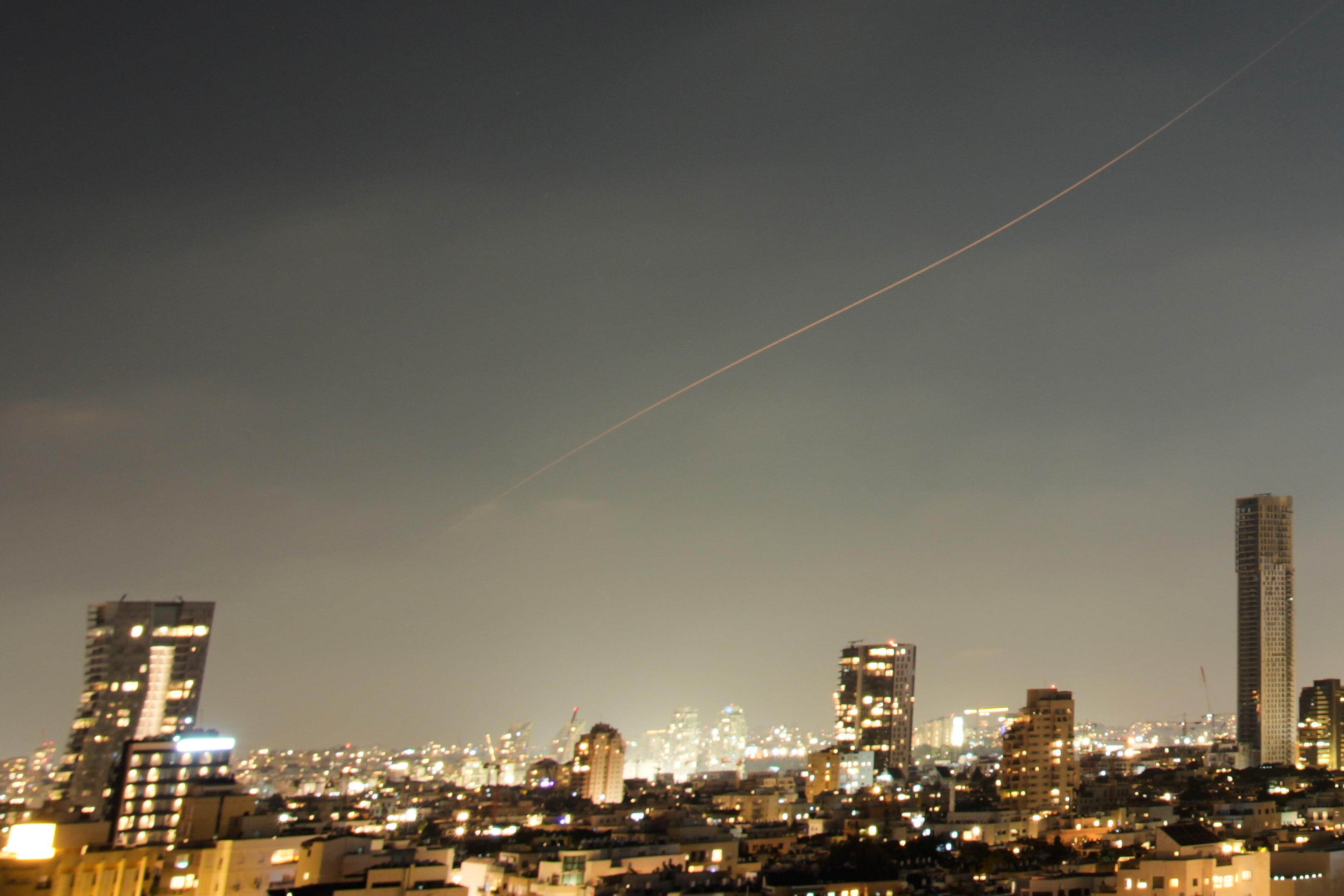 A projectile streaks through the sky over central Israel during an Iranian missile attack on Sunday. Photo: AP