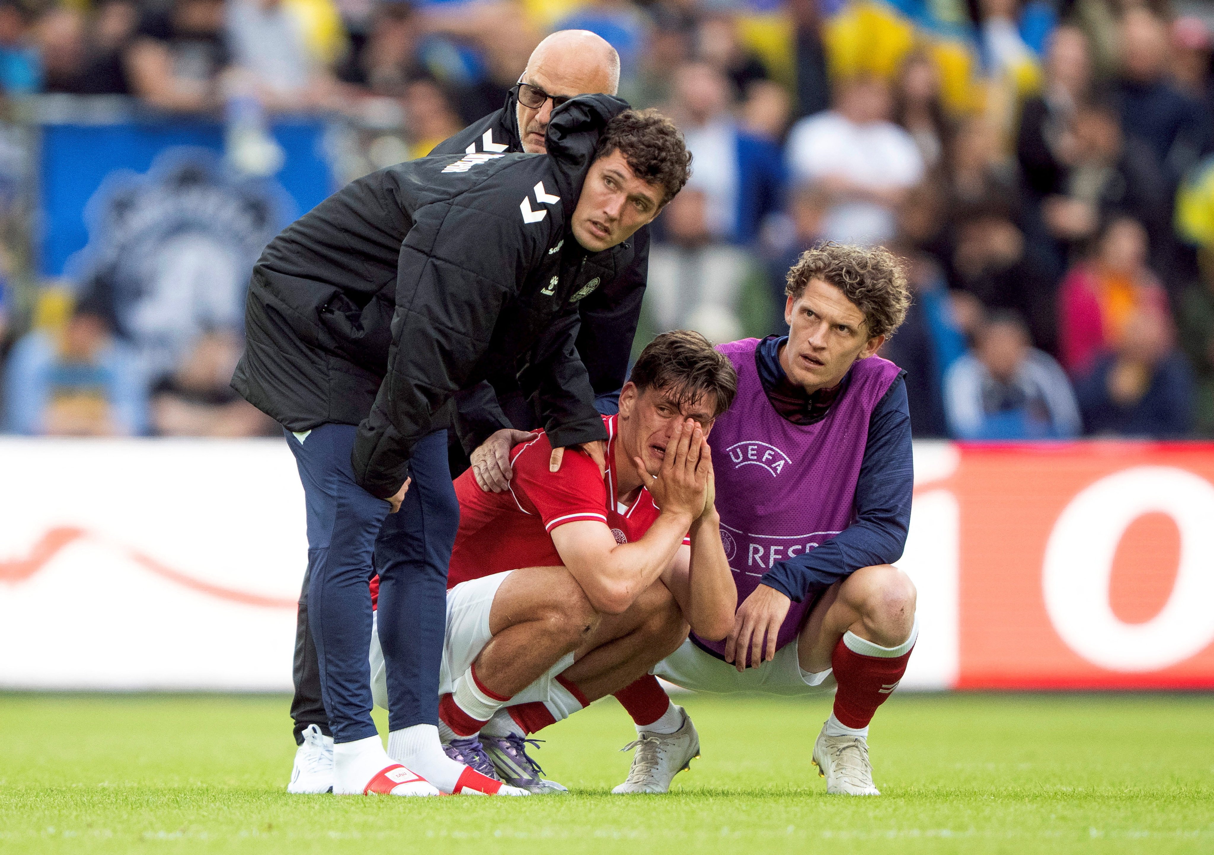 Denmark’s Joakim Maehle, Andreas Christensen and Jens Stage react after Christian Eriksen collapsed on the pitch in Odense, Denmark on Sunday. Photo: Ritzau Scanpix via Reuters