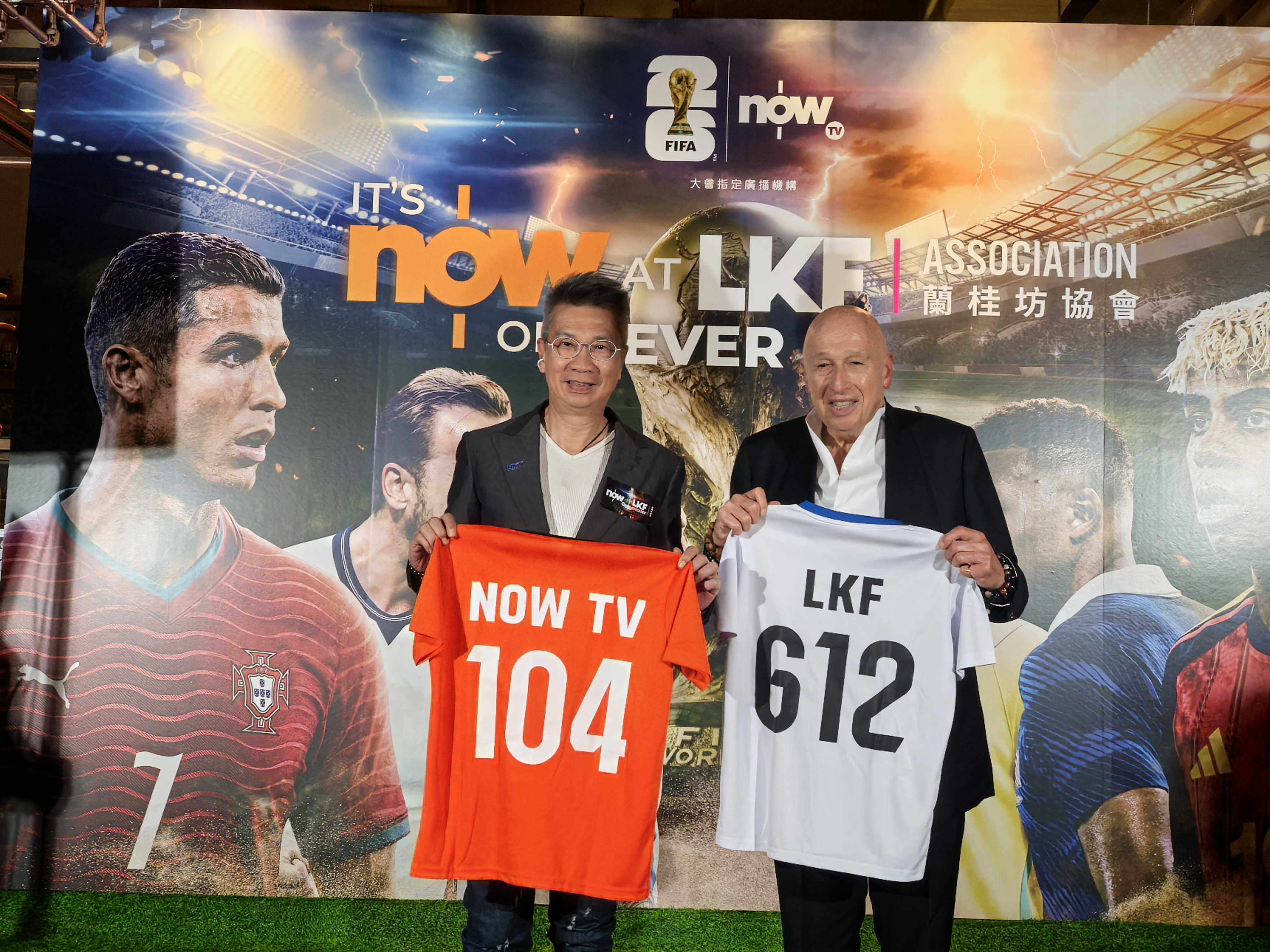 Bruce Lam (left) and Allan Zeman holding up shirts showing the number of World Cup matches Now TV will broadcast (104) and the day they begin, June 12. Photo: Ada Li