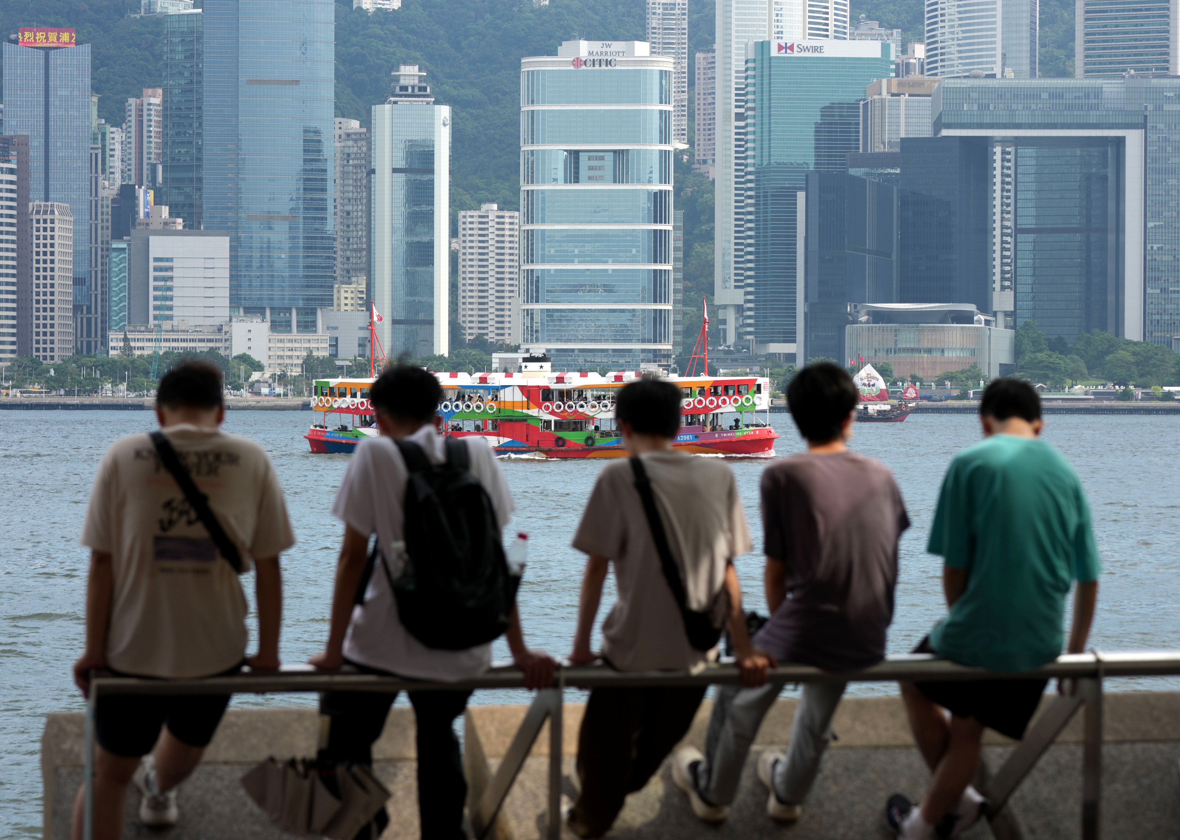 Young people sit along the Tsim Sha Tsui waterfront on June 5. Photo: Jelly Tse