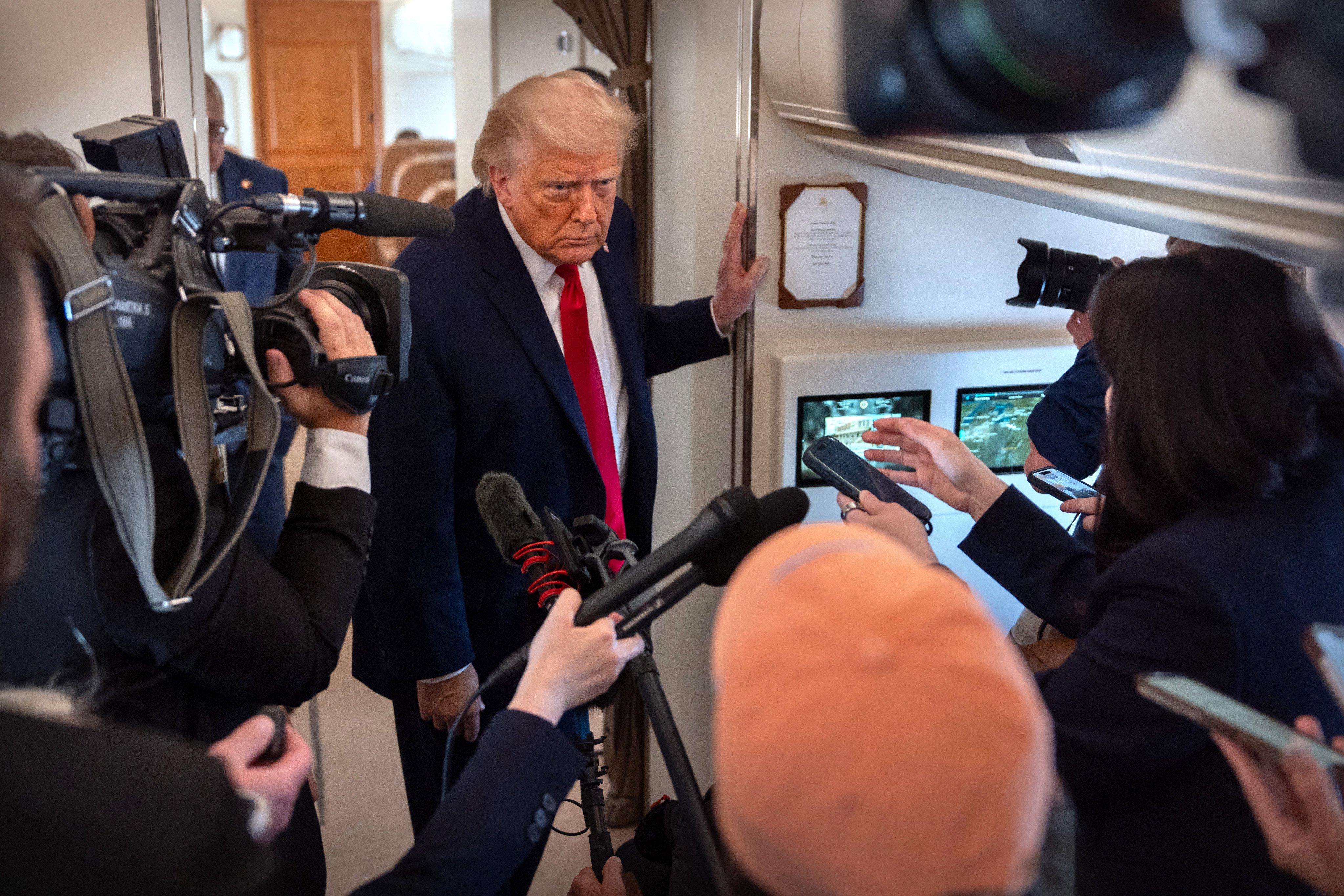 President Donald Trump speaking to reporters on Air Force One. Photo: AP