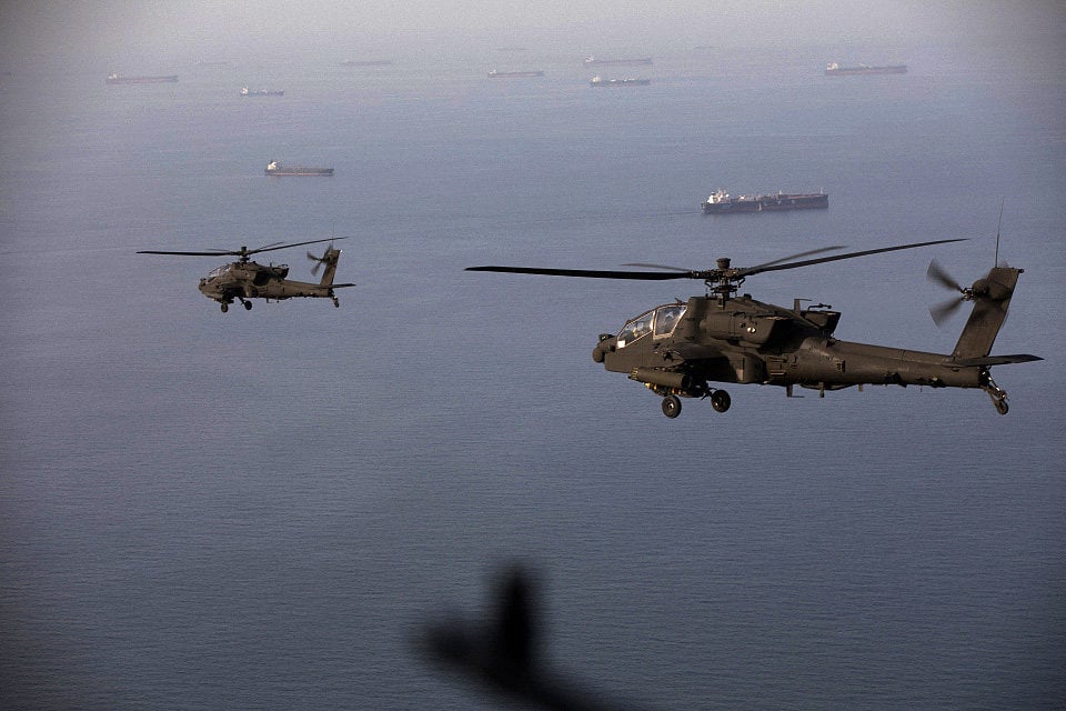 US Apache helicopters flying over the Strait of Hormuz on April 17. Photo: US Central Command via AFP