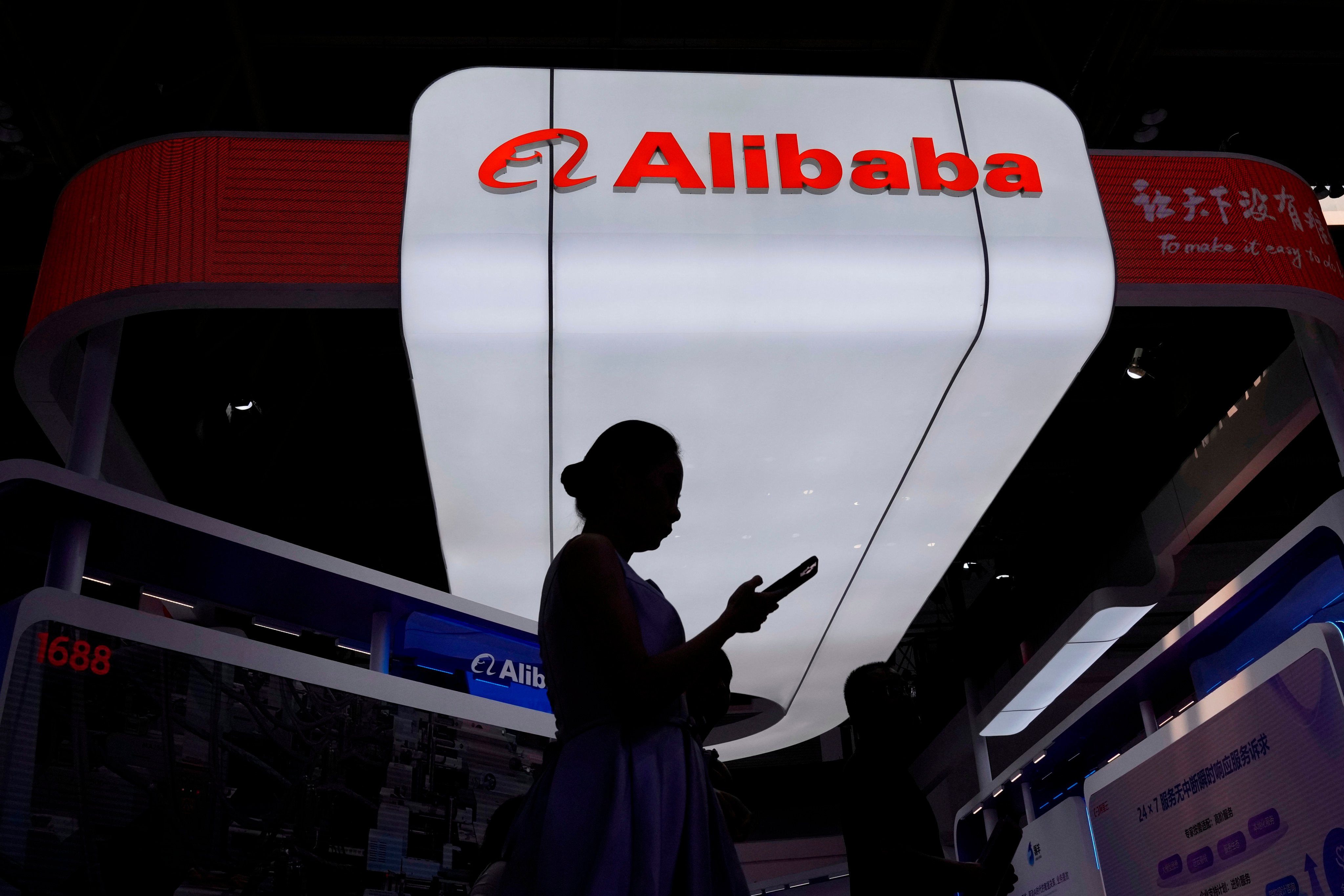A visitor walks in front of the Alibaba booth during the third China International Supply Chain Expo at the China International Exhibition Center in Beijing in July 2025. Photo: AP