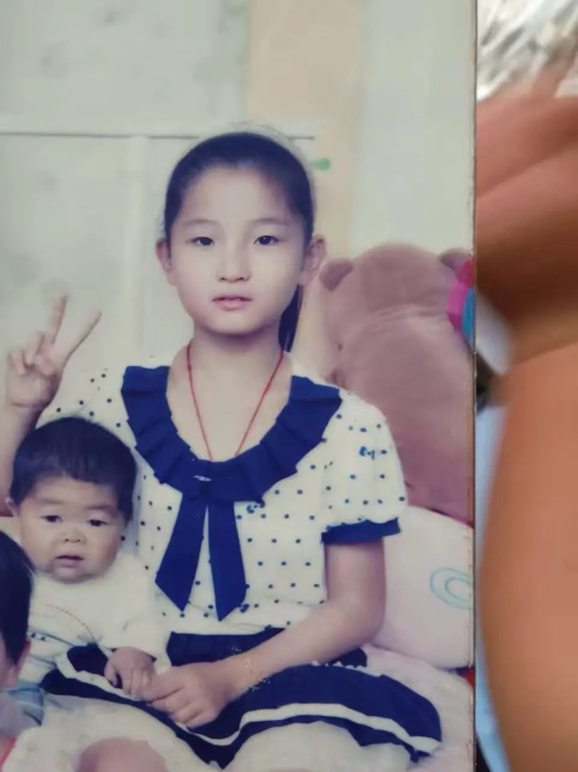 Wang Junming sits beside his younger sister, Xiaoling, when she was a child. Photo: Handout Wang Junming sits beside his younger sister, Xiaoling, when she was a child. Photo: Handout