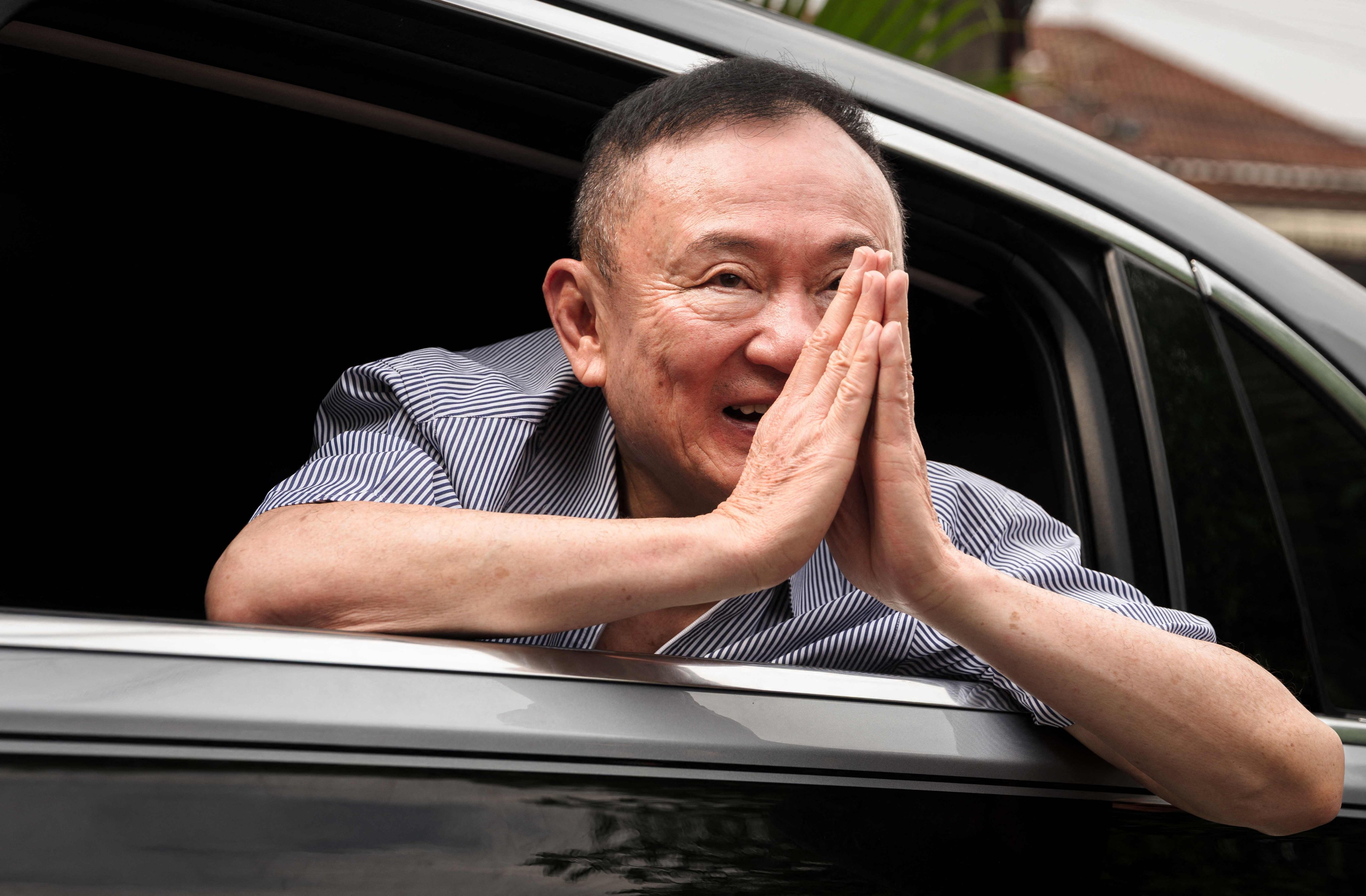 Former Thai prime minister Thaksin Shinawatra thanks supporters upon arriving back home after his release from Klong Prem Central Prison in Bangkok on May 11. Photo: AFP