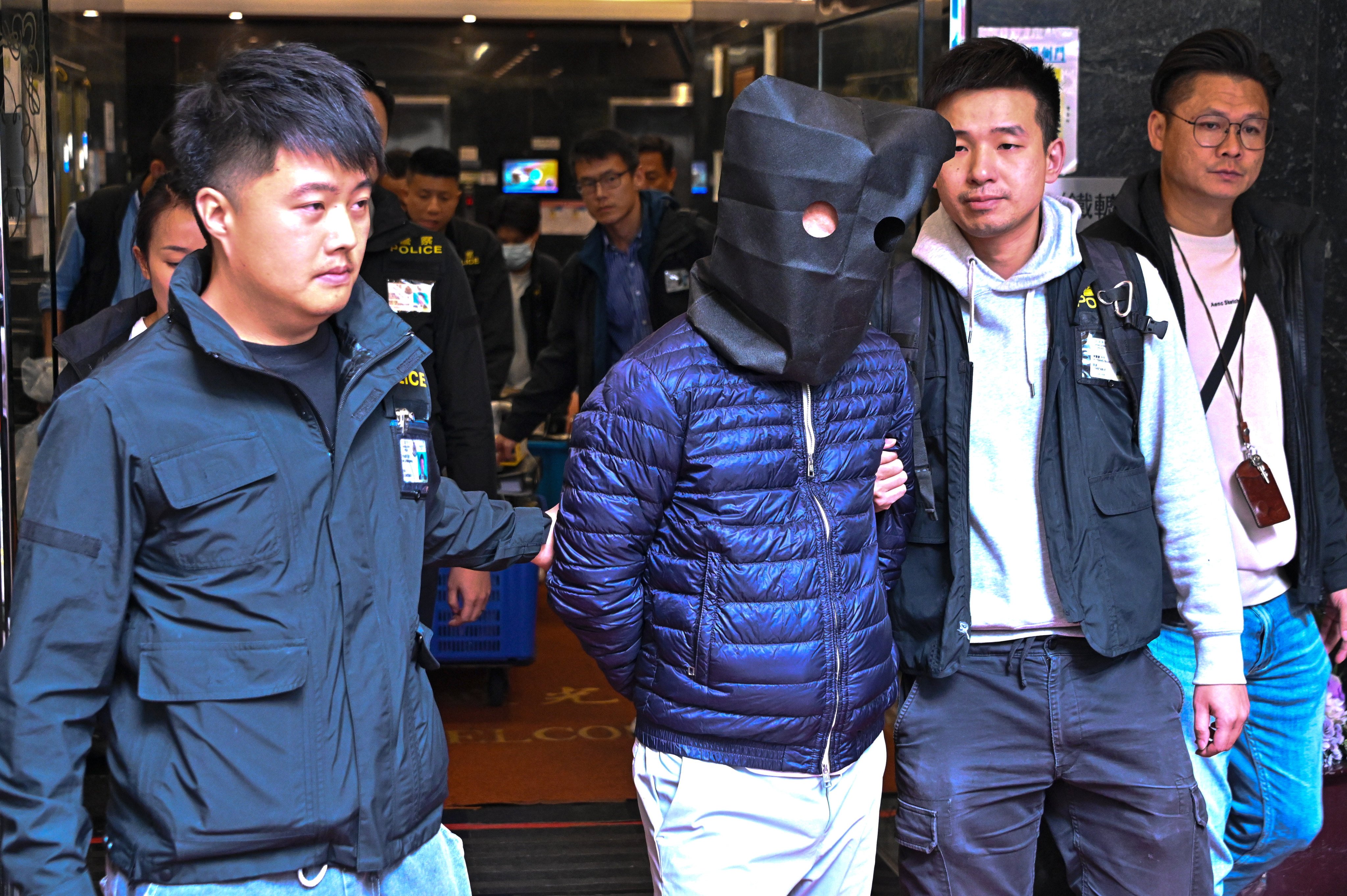 Police search the office of Prestige Construction and Engineering, following the arrest of three men, including its two directors, on suspicion of manslaughter, on November 27, 2025. Photo: Handout