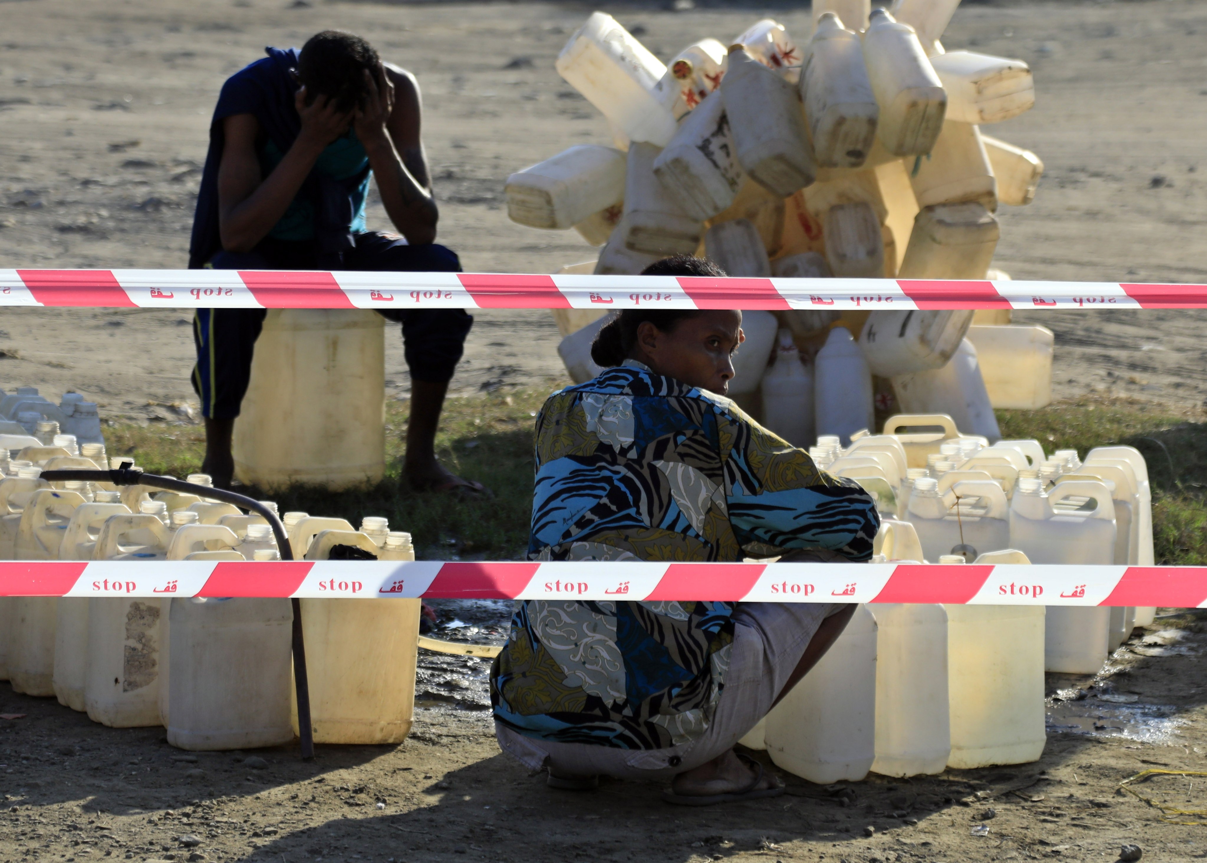 East Timorese residents sit next to plastic water containers as they wait for their turn to fill up at a public water station in Dili, East Timor, also known as Timor-Leste, in July 2019. Photo: EPA-EFE