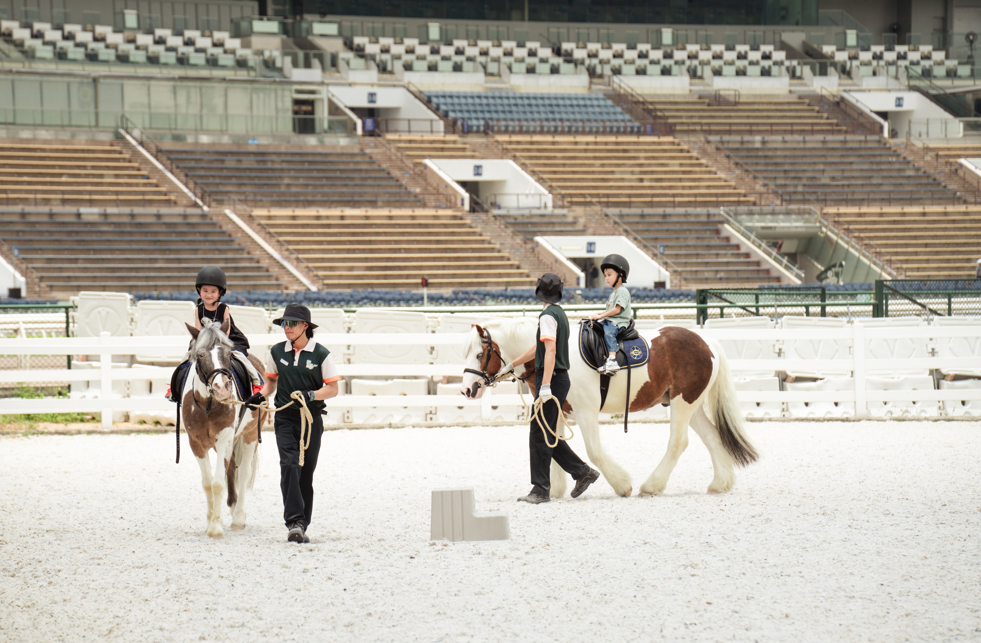 Children as young as three can ride ponies, guided by equestrian coaches, at Pony World. Photo: Alexander Mak