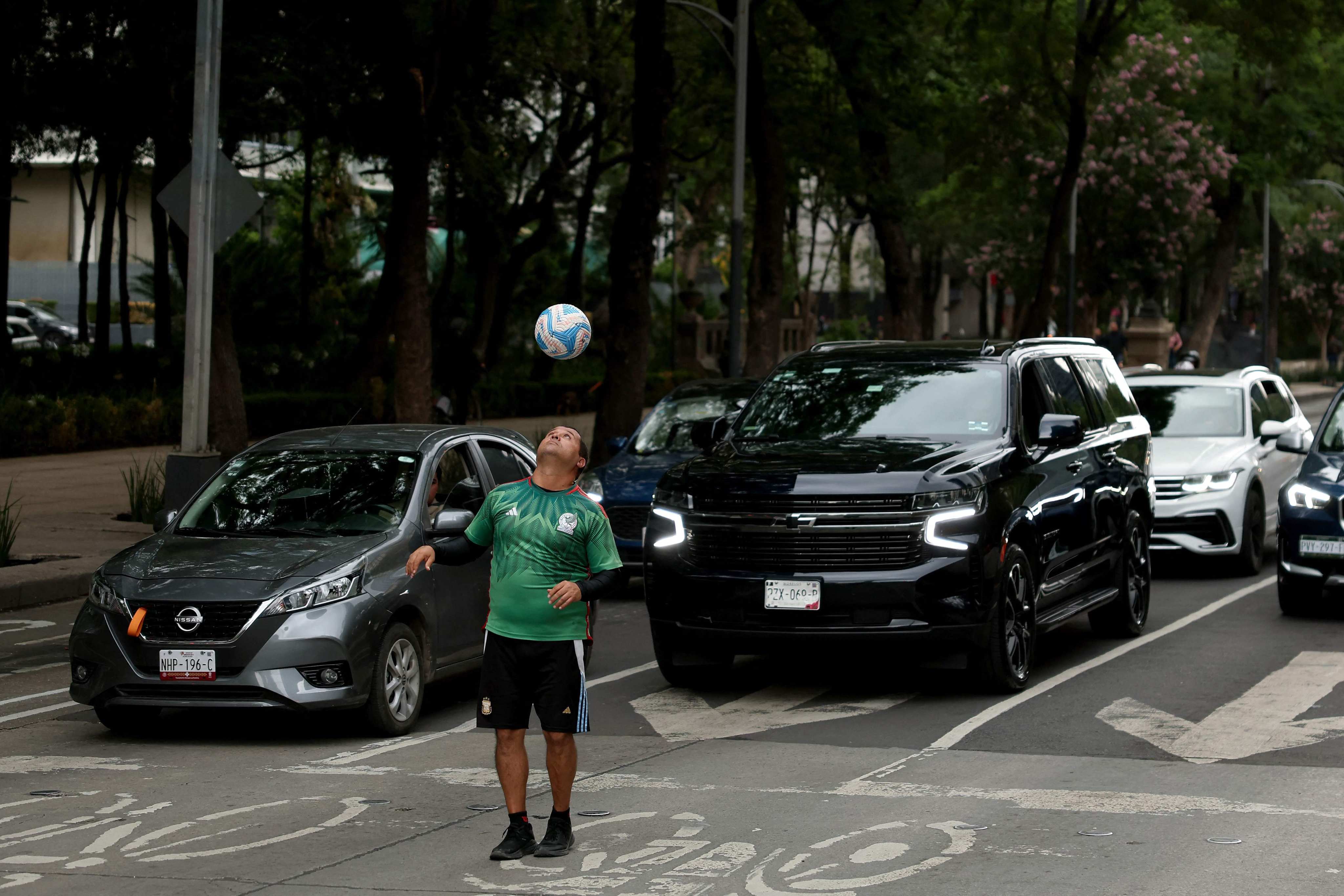 A man plays football on the street in Mexico City. Photo: Getty Images