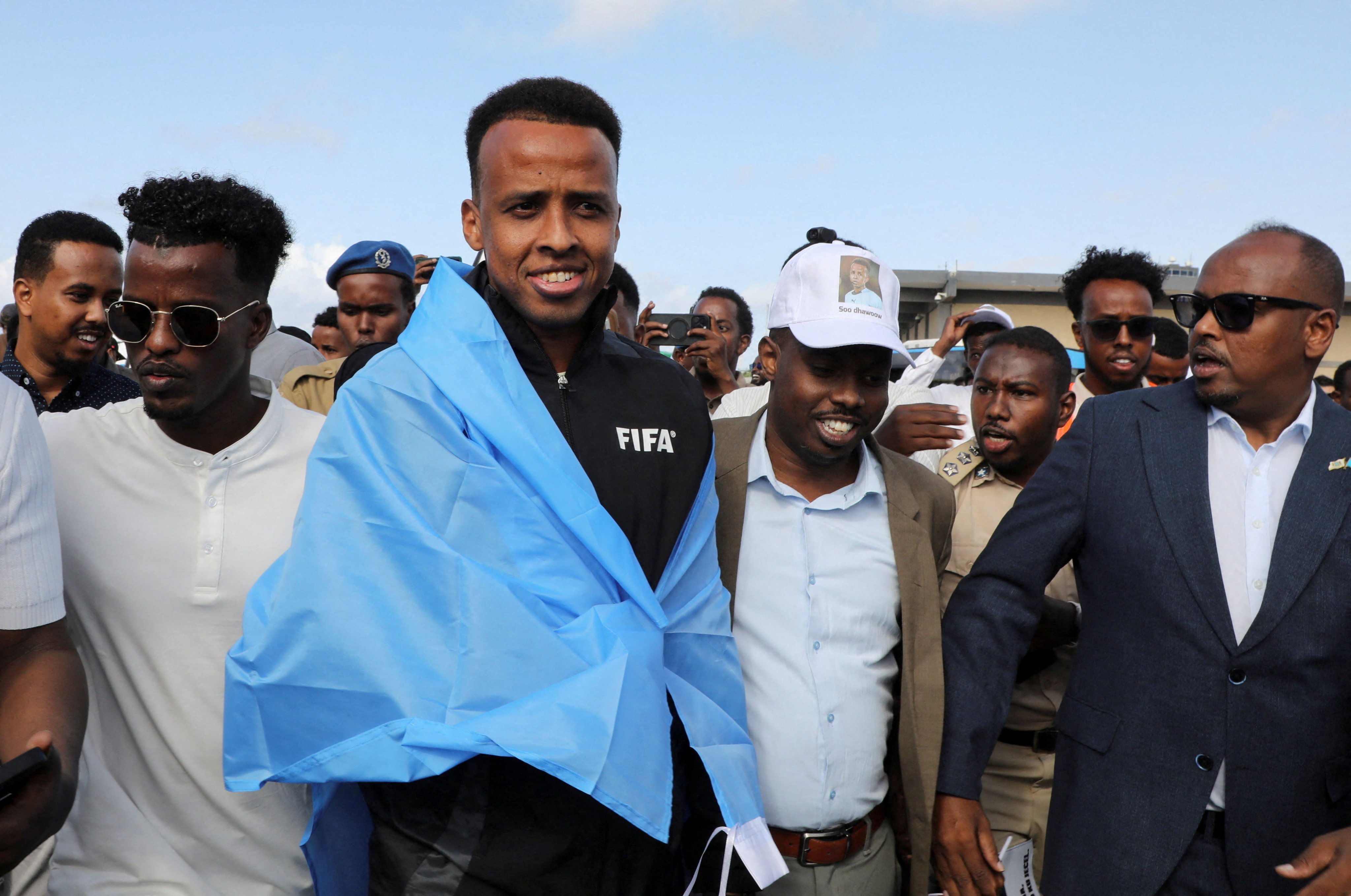 Somali referee Omar Artan (middle), who was denied entry to the US, arrives at the Aden Abdulle Osman International Airport in Mogadishu, Somalia on Tuesday. Photo: Reuters