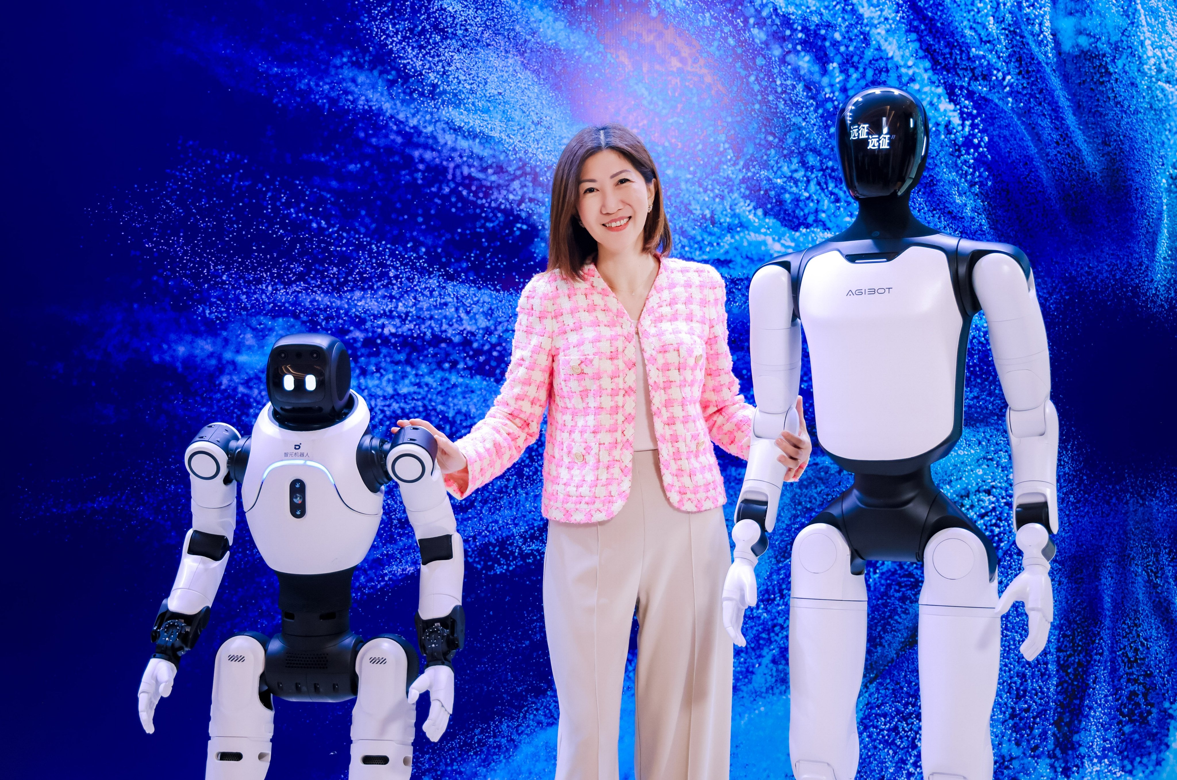 Bonnie Chan Yiting, CEO of Hong Kong Exchanges and Clearing, poses with humanoid robots at the bourse operator's    Future Tech Summit in Shenzhen on Thursday. Photo: Handout