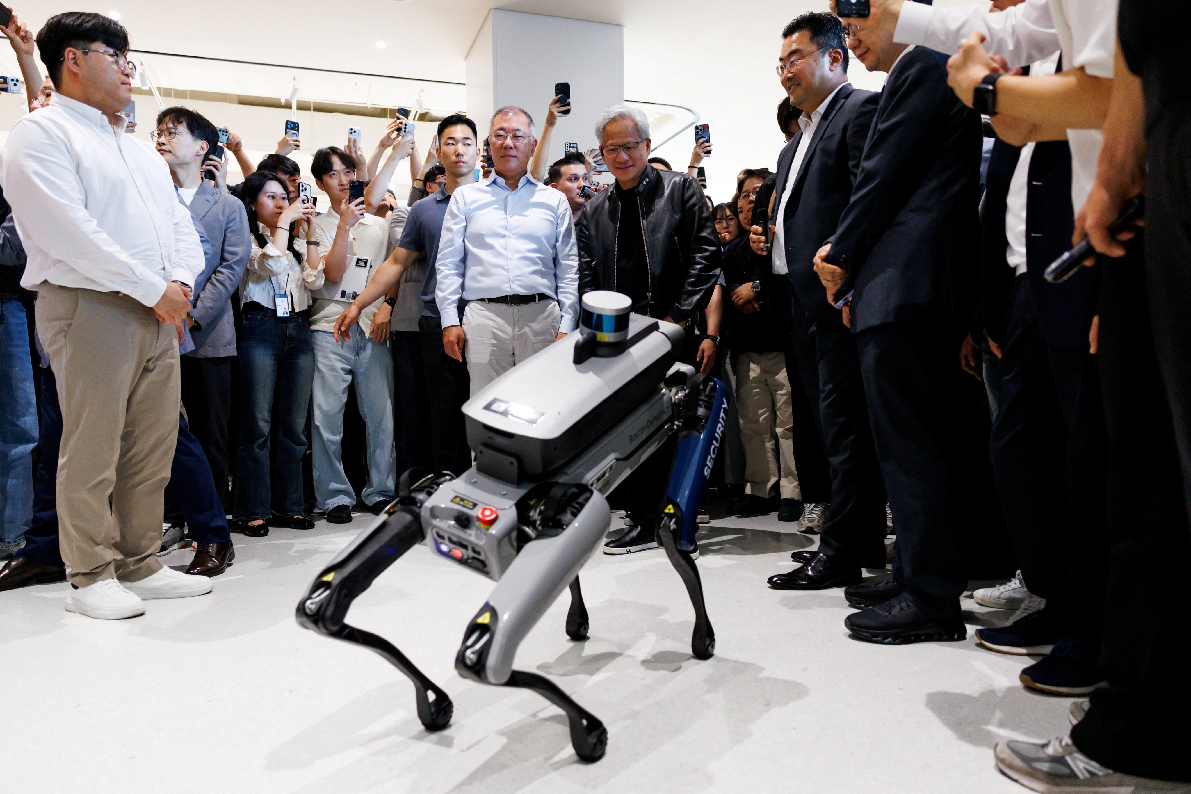 Nvidia CEO Jensen Huang (centre) looks at a Boston Dynamics Spot robot at the Hyundai Motor Group headquarters in Seoul on Monday. Photo: Reuters