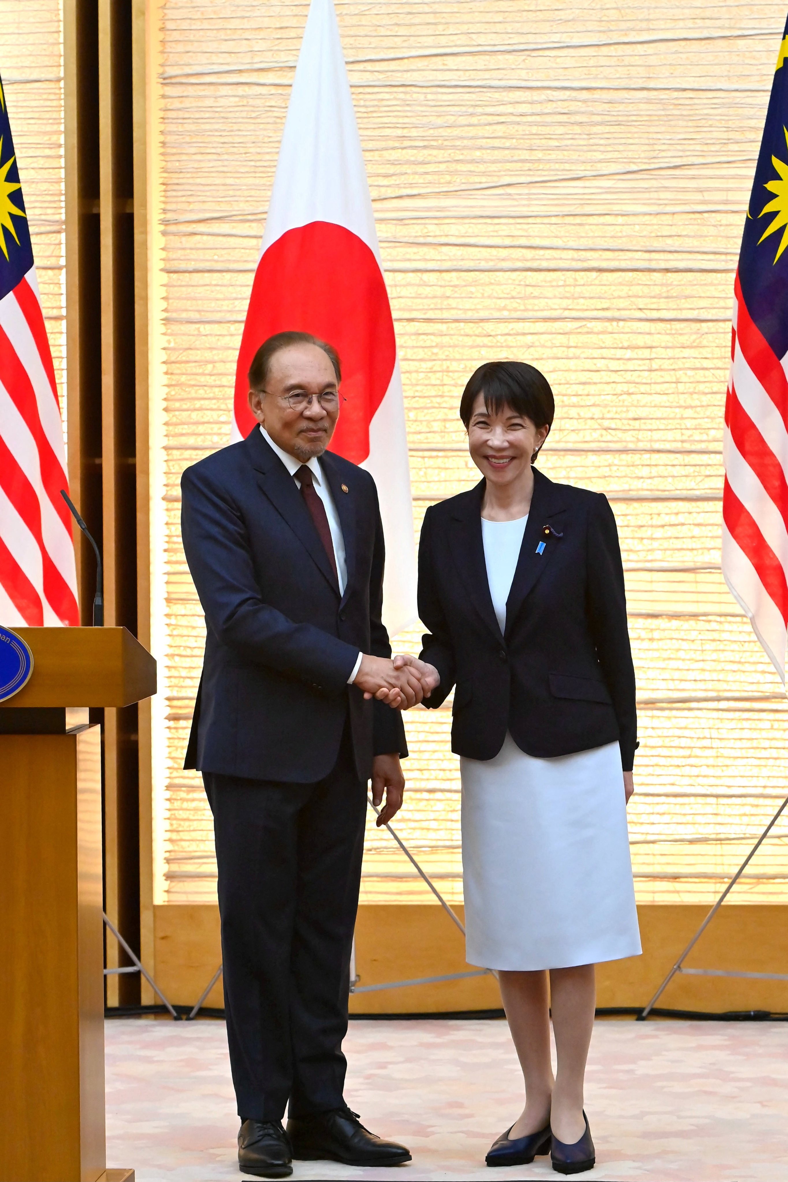 Japanese Prime Minister Sanae Takaichi (right) and her Malaysian counterpart, Anwar Ibrahim, shake hands at the end a joint press announcement at the Prime Minister’s Office in Tokyo on Wednesday. Photo: Reuters