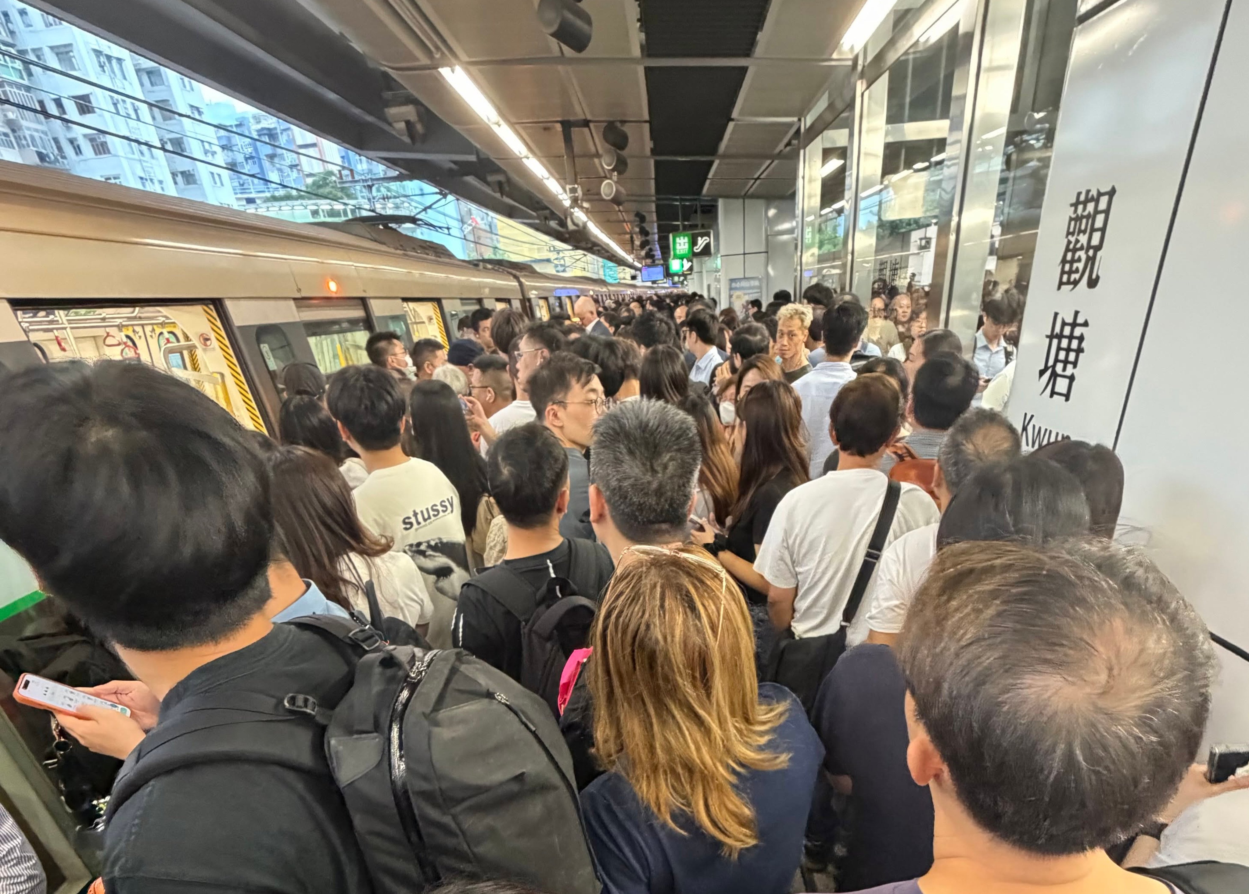 Passengers wait at a station amid an equipment failure along the Tseung Kwan O line. Photo: Handout