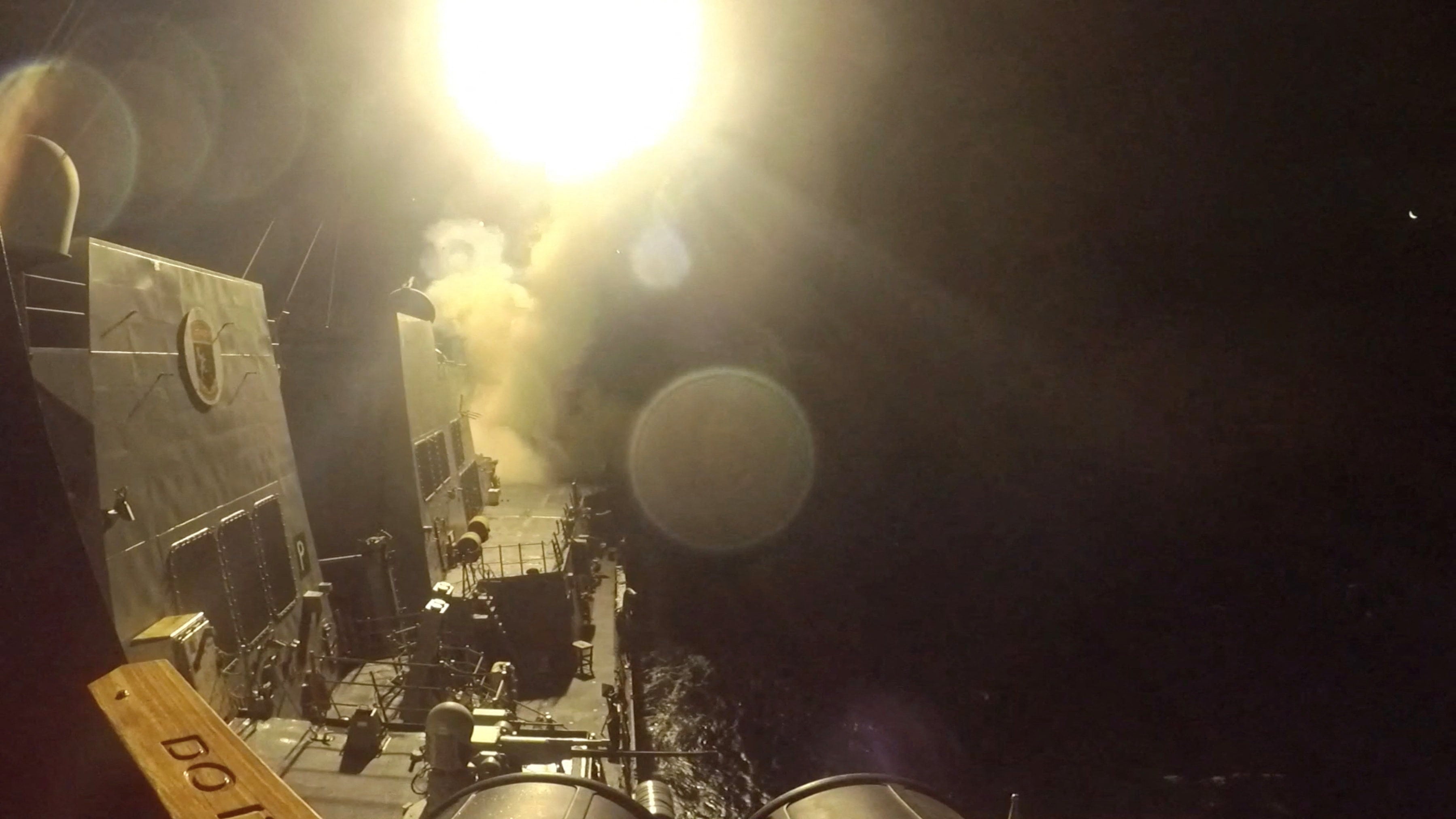 The USS Michael Murphy launching Tomahawk cruise missiles from an unknown location. Photo: CENTCOM via Reuters