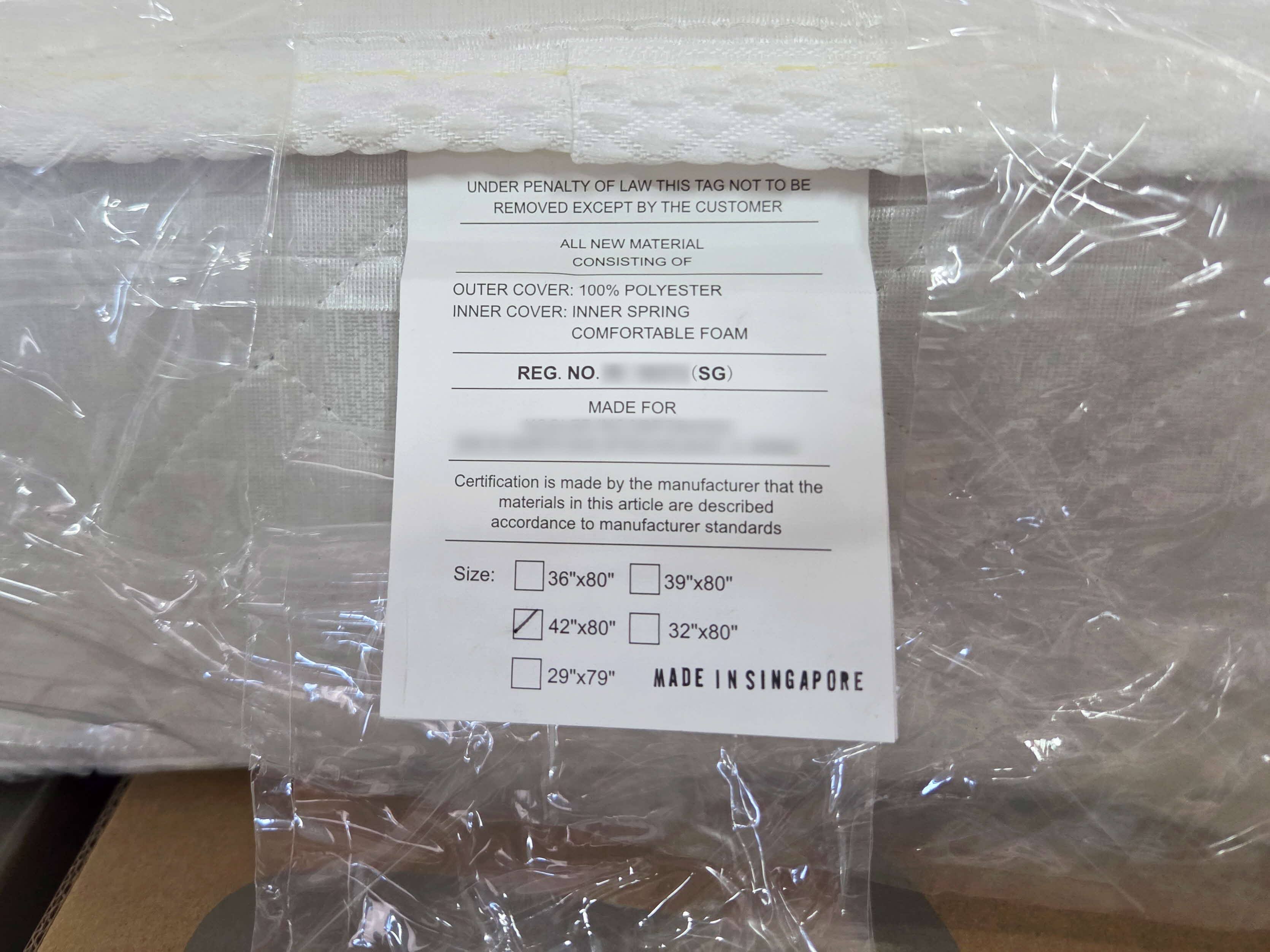 A seized mattress bears an allegedly falsified “Made in Singapore” stamp on its tag. Photo: Singapore Customs