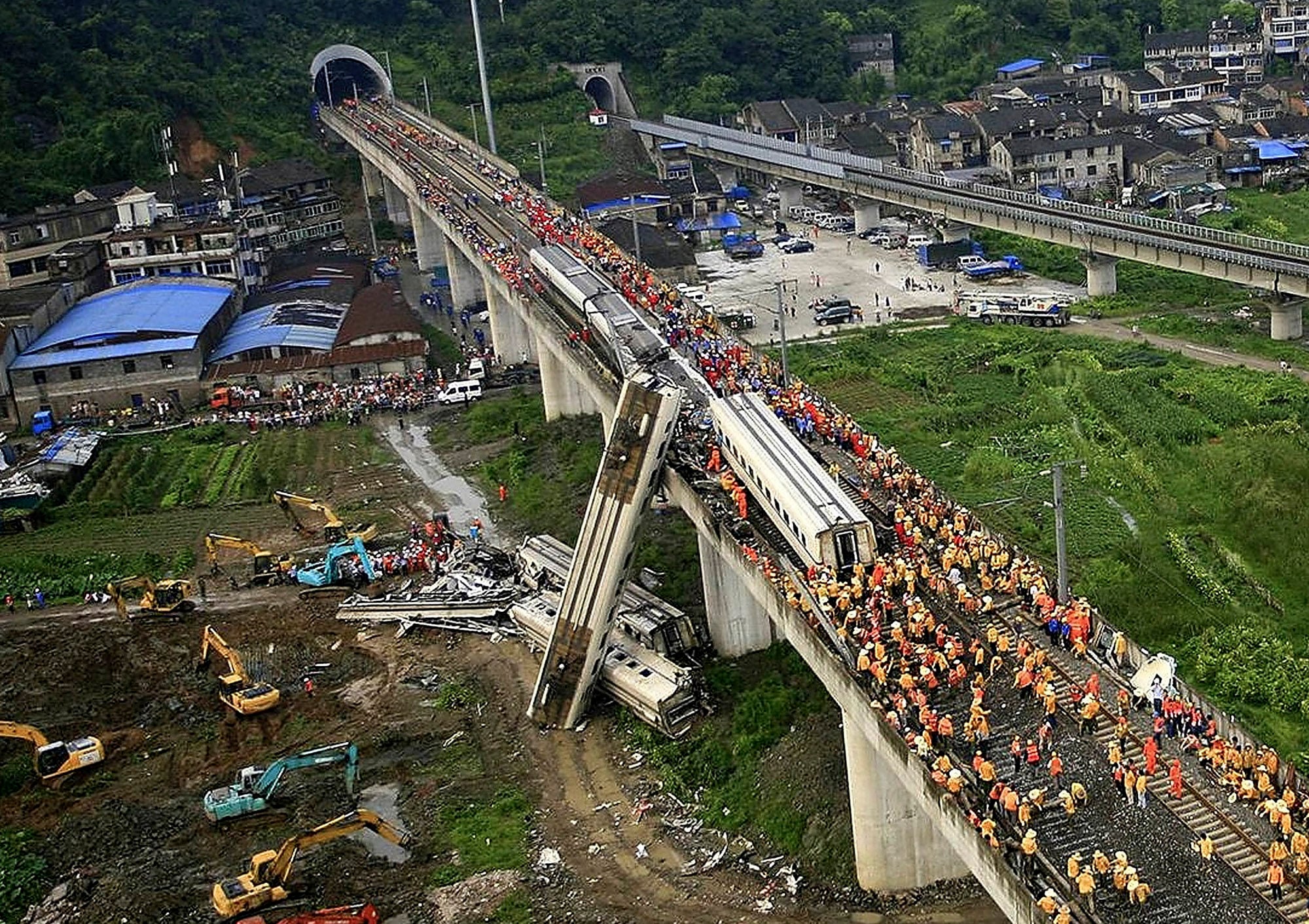 Chinese rescuers work around the wreckage of train cars in Wenzhou in east China’s Zhejiang province on Sunday, July 24, 2011, after a bullet train crashed into another high-speed train, killing 40 people. Photo: AP/Color China Photo/China Out