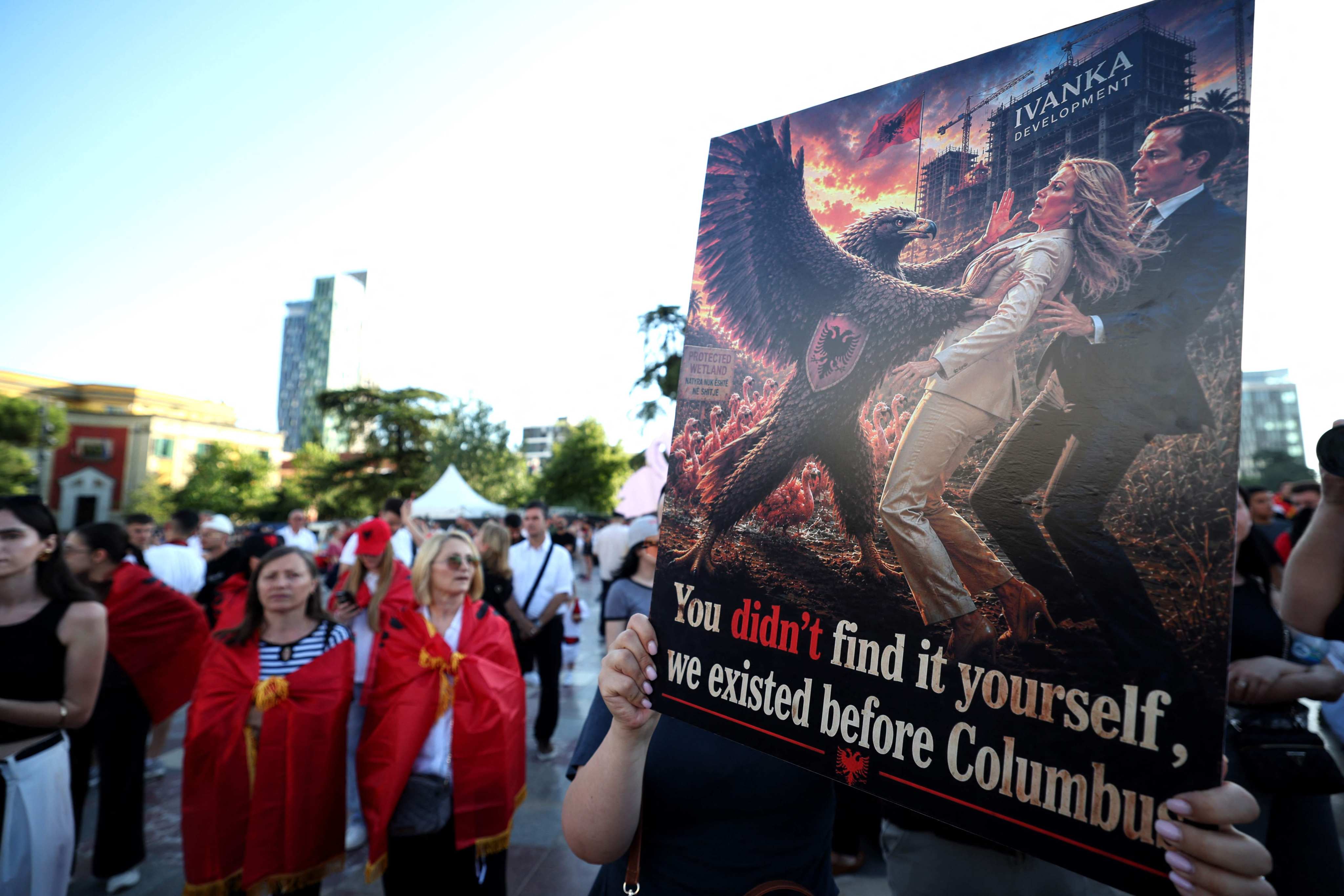 Protesters hold a poster depicting Ivanka Trump and Jared Kushner in Tirana on Wednesday. Photo: AFP