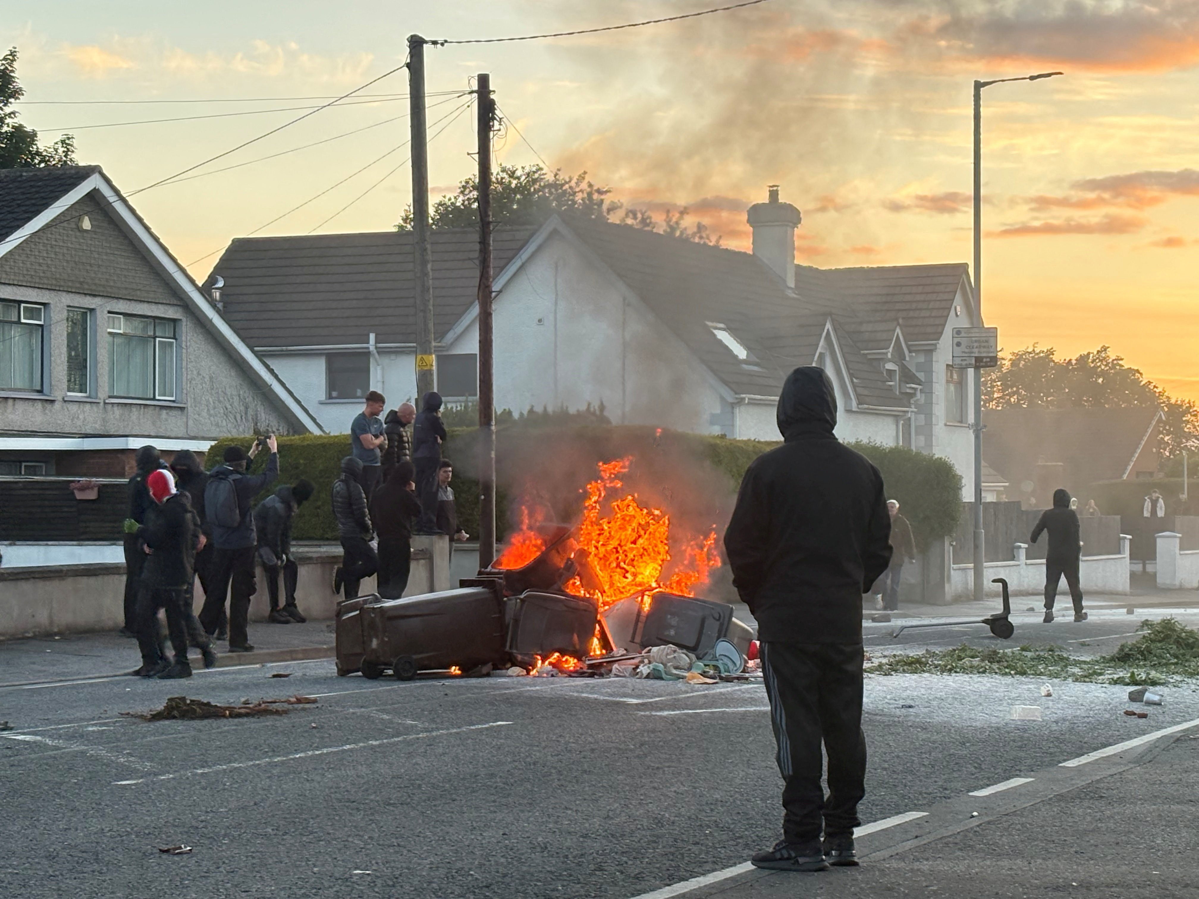A fire burns in bins as protesters clash with police. Photo: Reuters