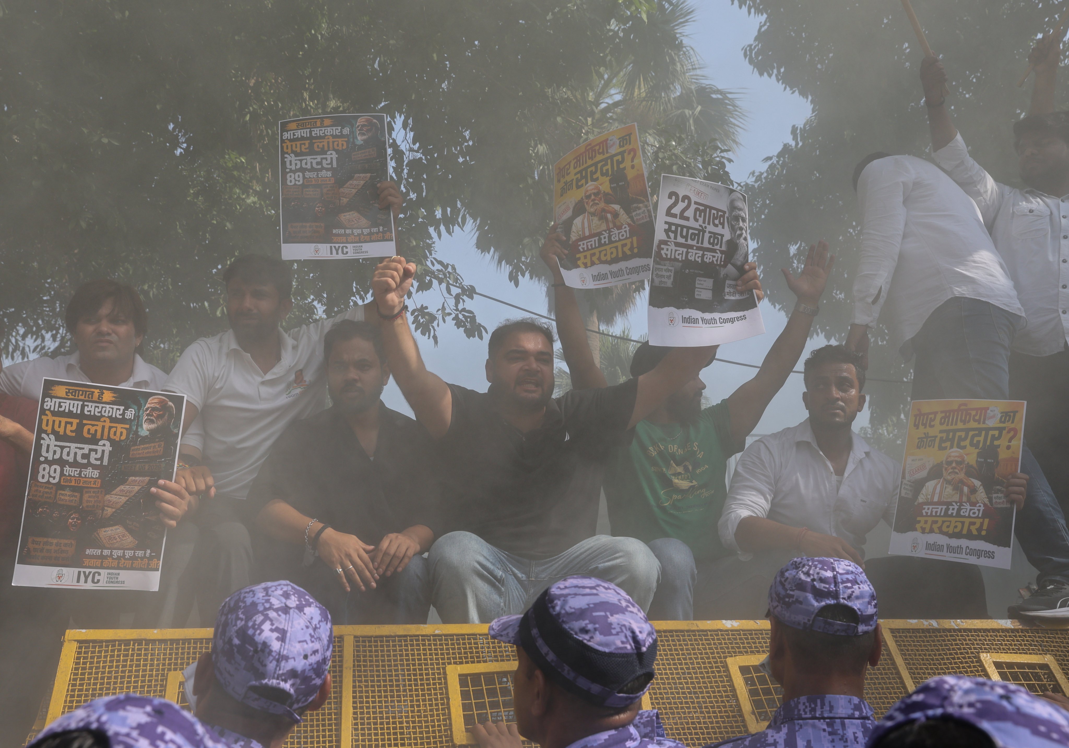 Indian Youth Congress activists climb police barricades as they protest against the exam scandals outside the National Testing Agency office in New Delhi on May 13. Photo: EPA