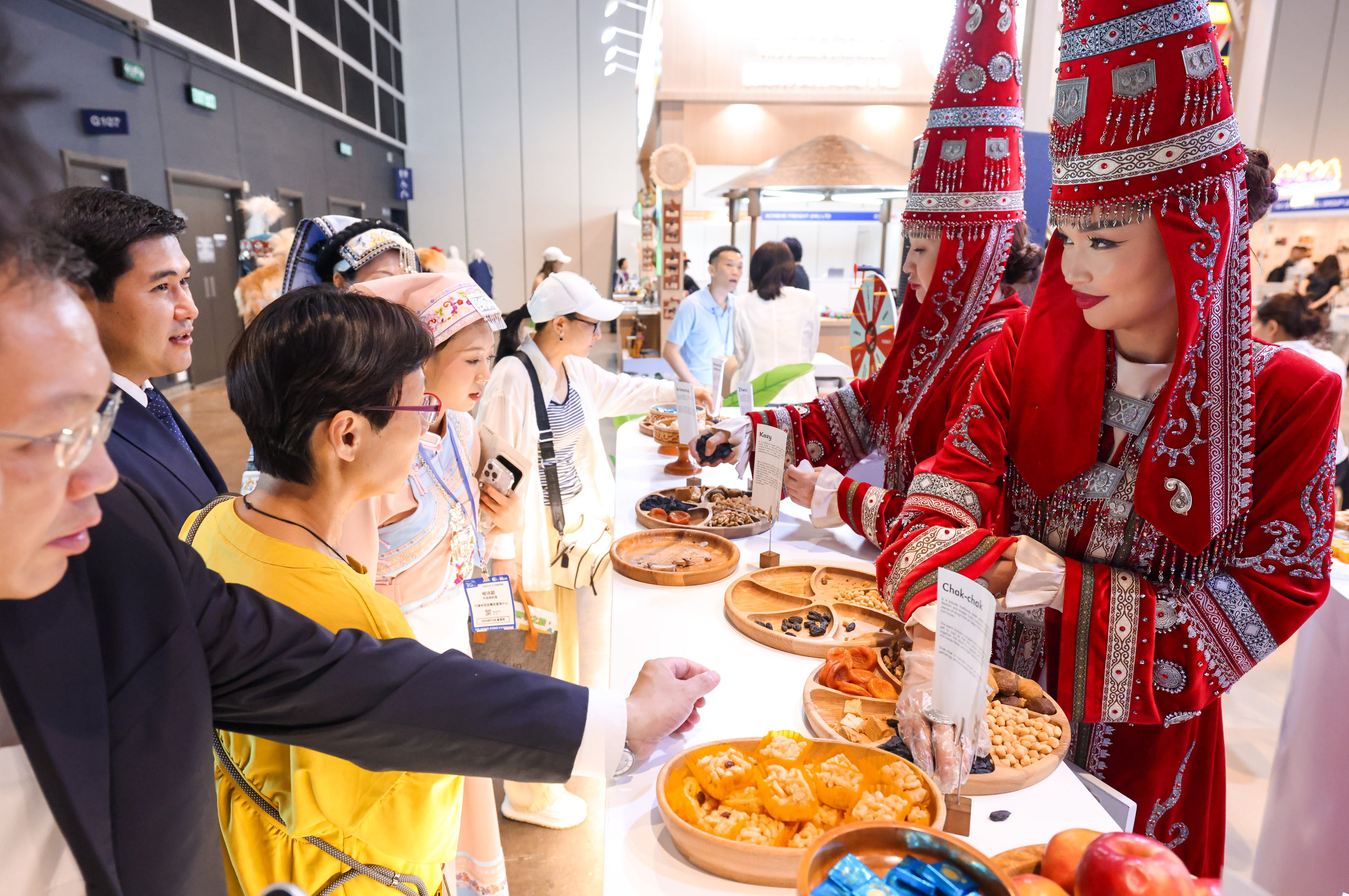 Visitors at the expo sample Kazakh treats at the "Visit Almaty” booth. Photo: Nora Tam