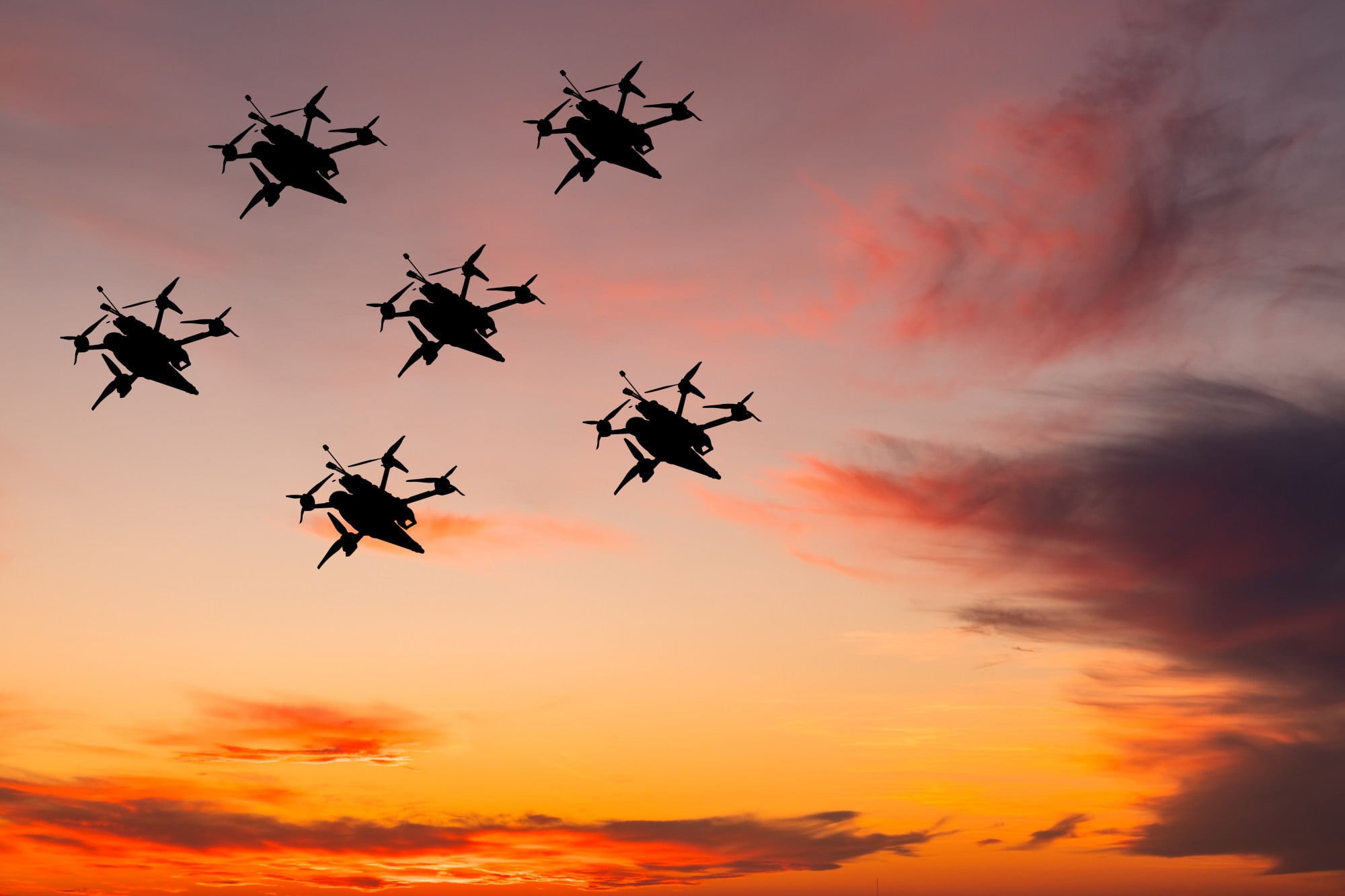 Half a dozen drones pictured in silhouette against a dramatic sky. Photo: Getty Images Half a dozen drones pictured in silhouette against a dramatic sky. Photo: Getty Images