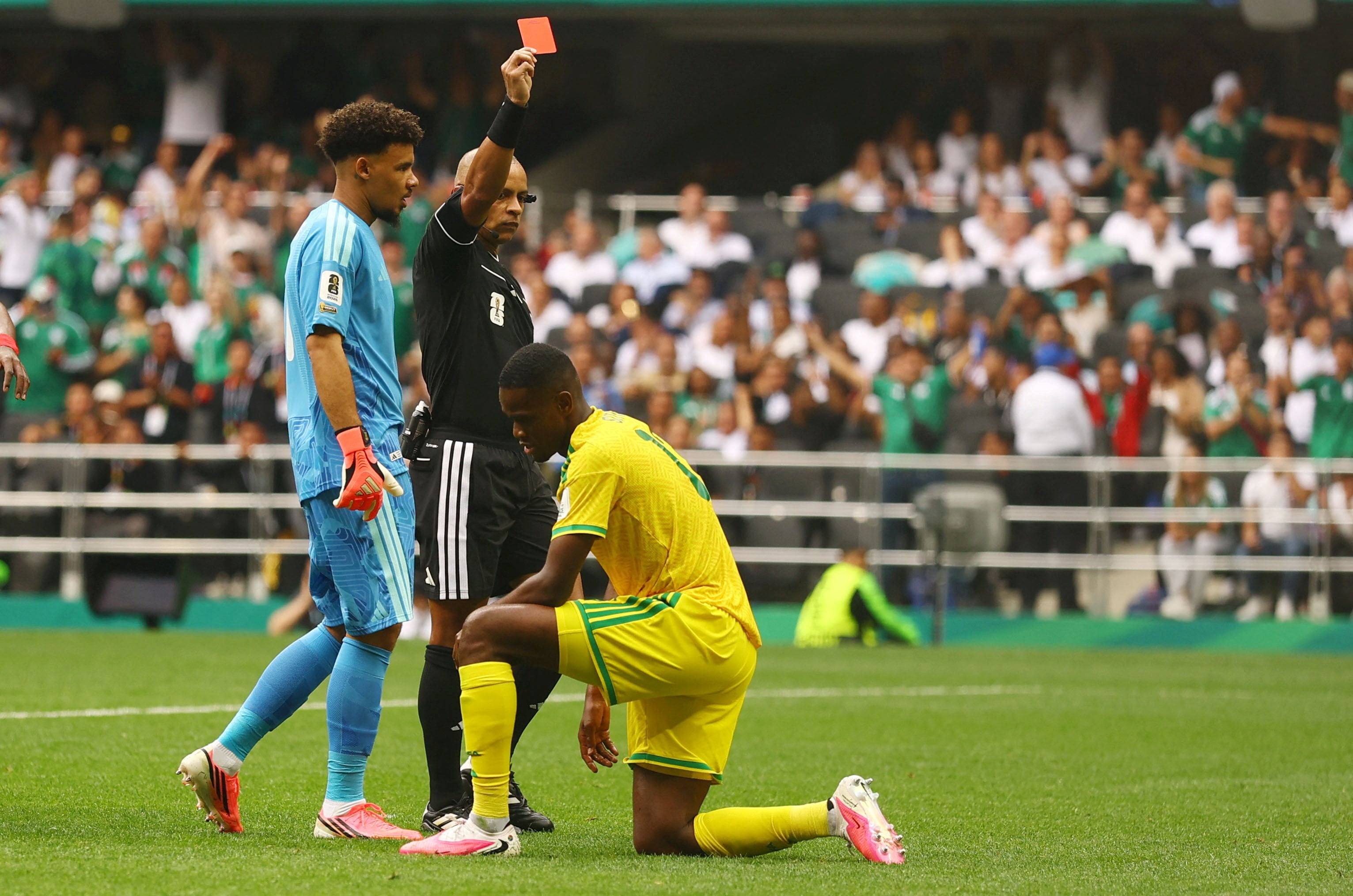 South Africa’s Sphephelo Sithole (right) is sent off by referee Wilton Sampaio. Photo: Reuters