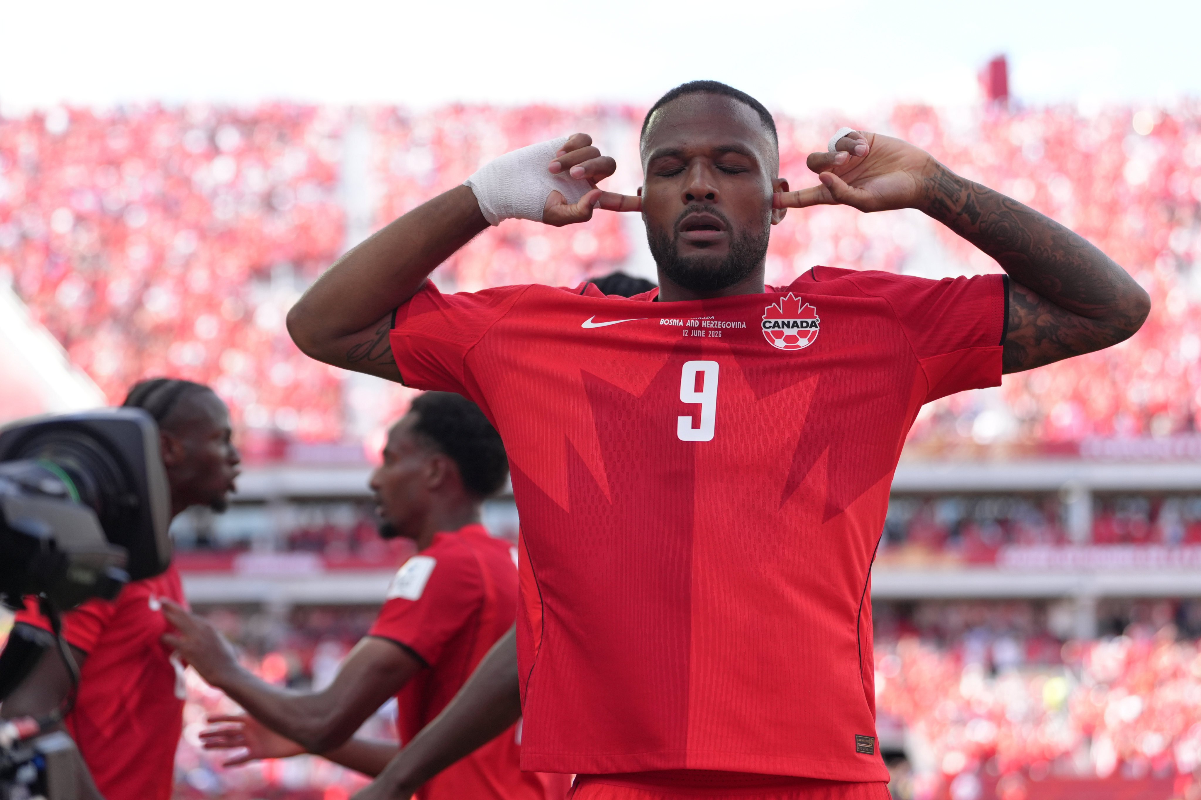 Canada’s Cyle Larin takes a moment and shuts out the noise after scoring his side’s equaliser. Photo: AP