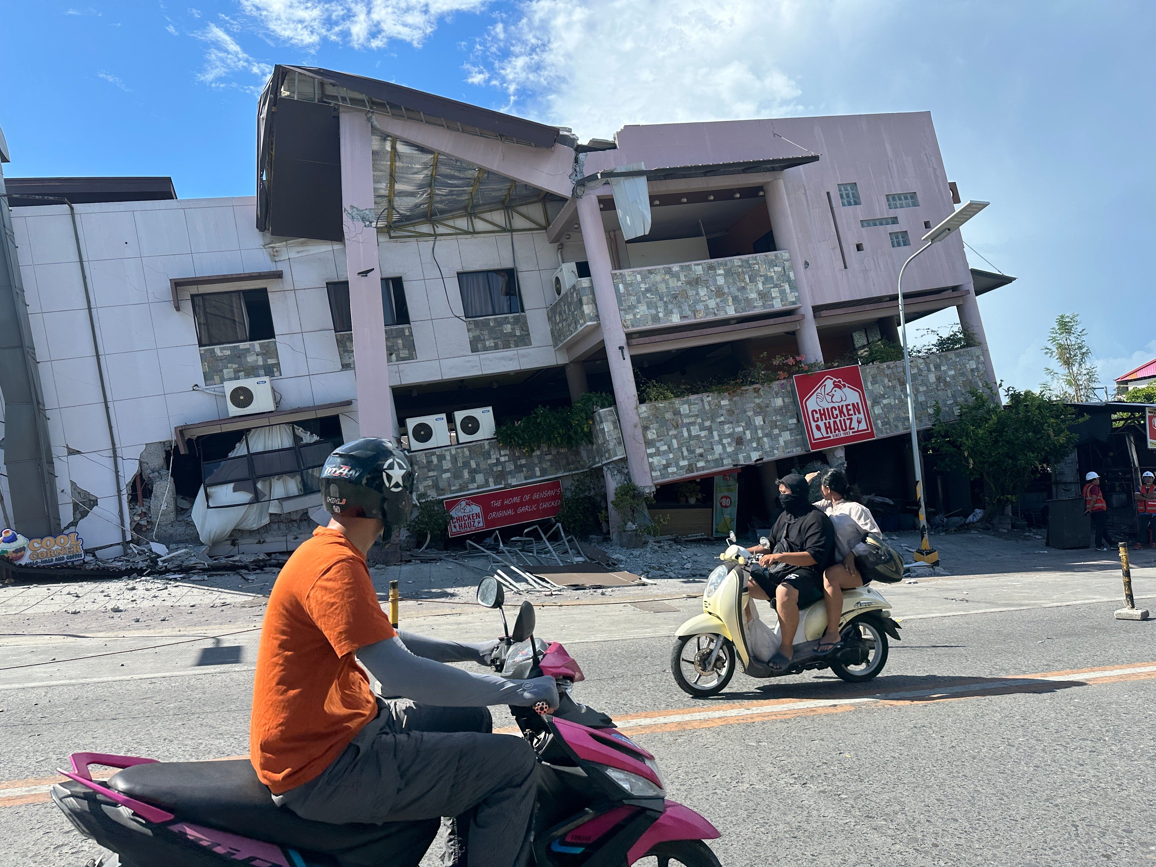 Residents pass by a collapsed building in General Santos, Philippines on Monday, June 8, 2026. Photo: AP