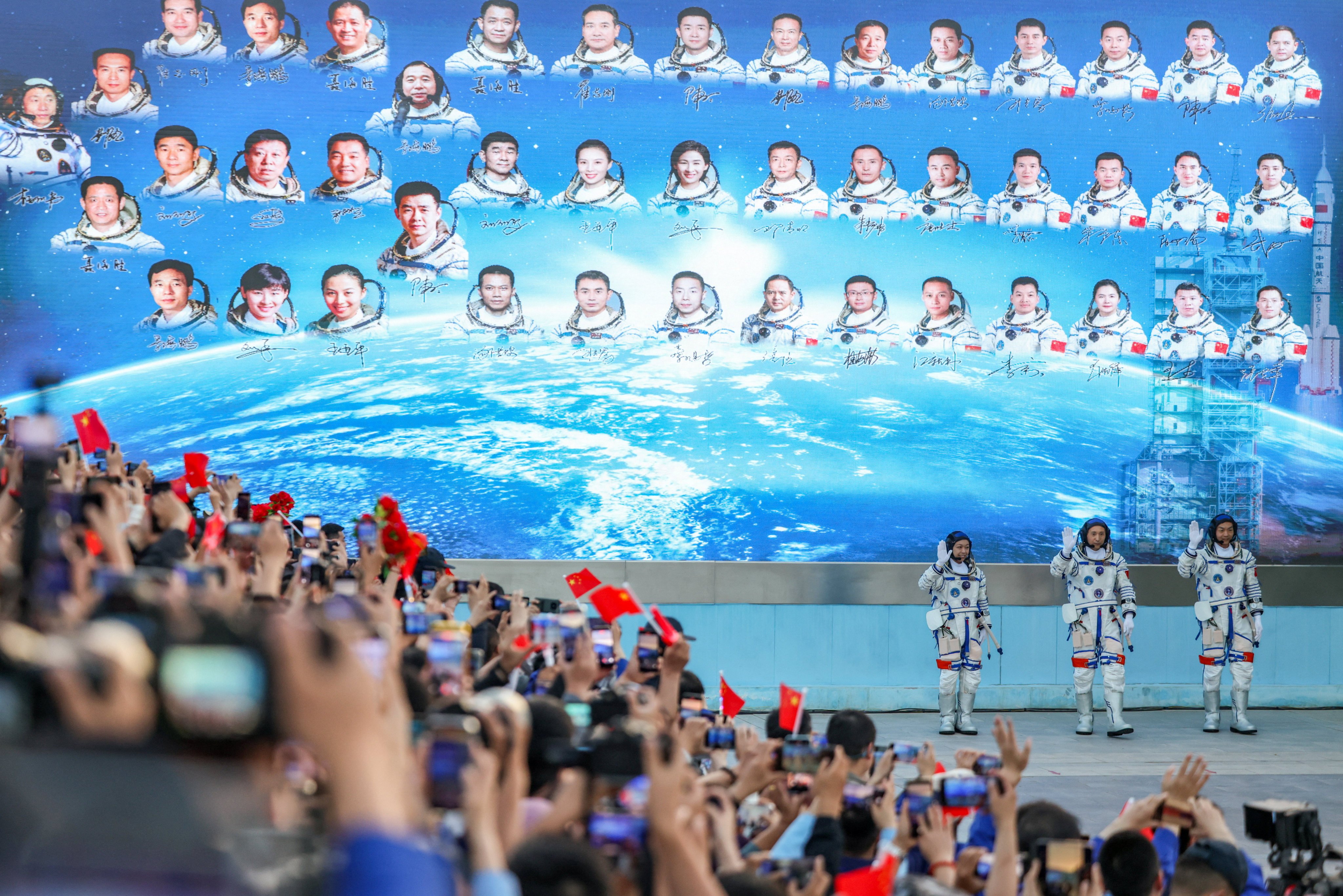 A crowd shows their appreciation for astronauts Lai, Zhu Yangzhu and Zhang Zhiyuan ahead of launch. Photo: Reuters