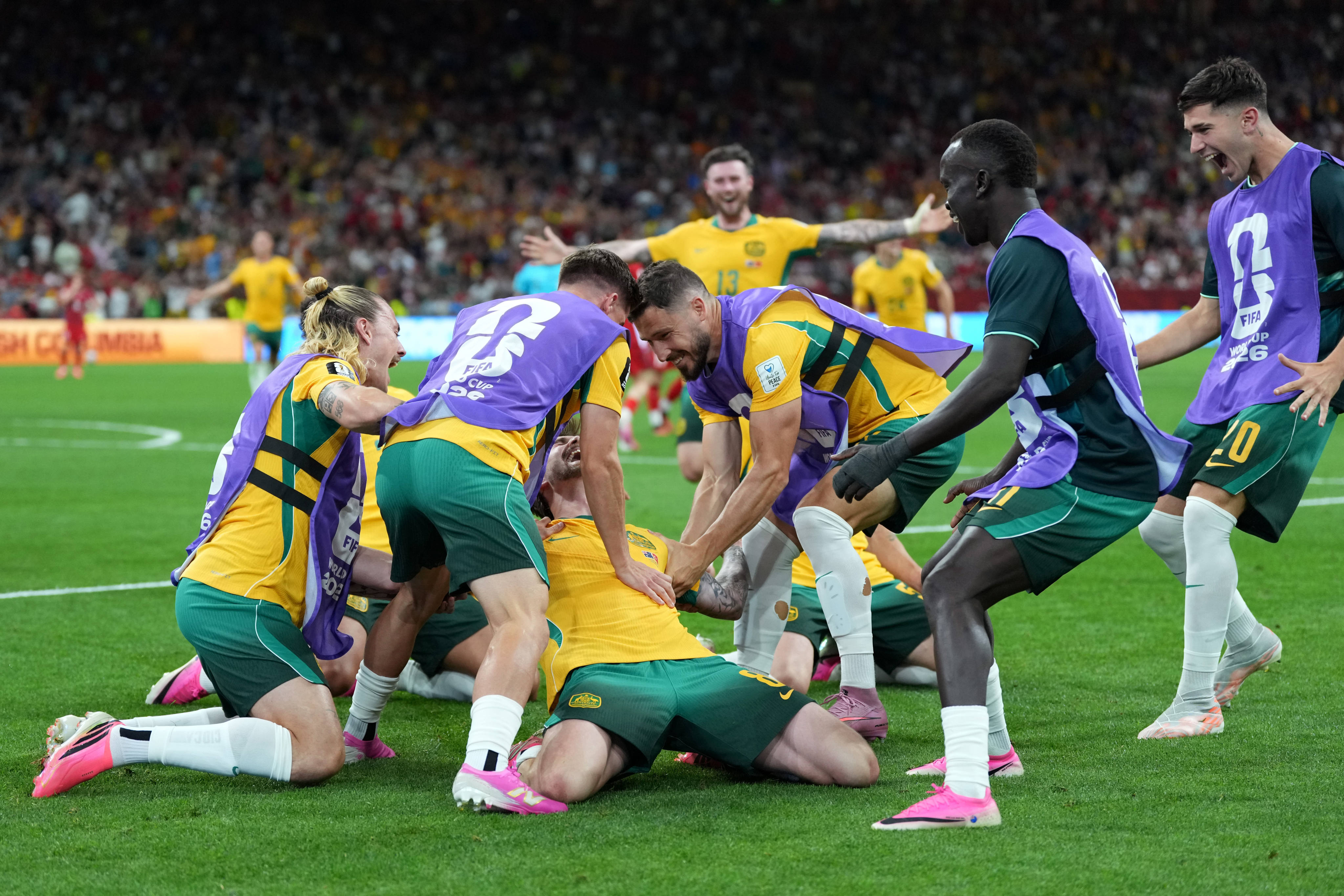 Australia’s Connor Metcalfe (centre) celebrates with teammates after scoring the second goal against Turkey at the World Cup. Photo: AP