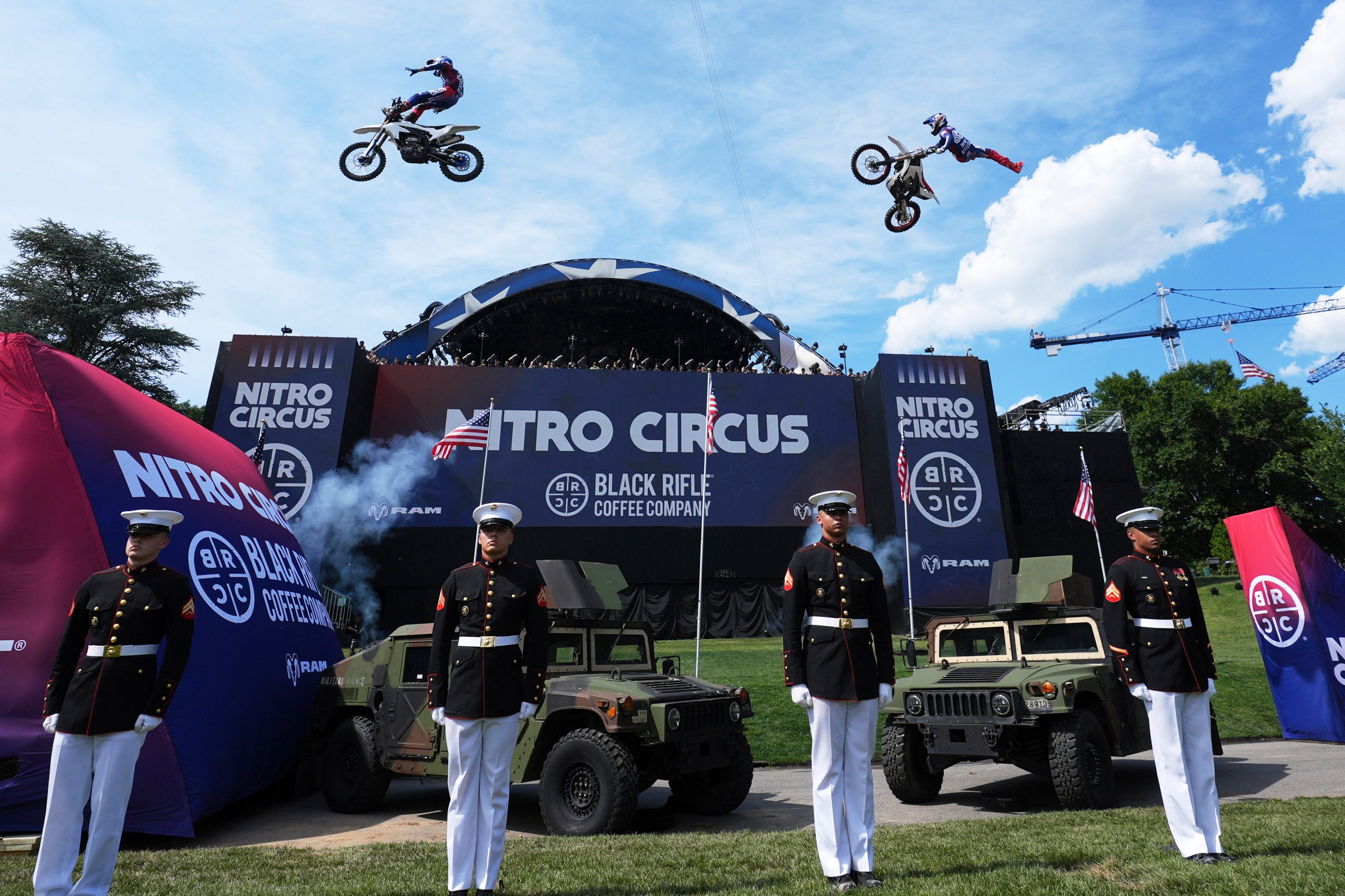 Motorsports athletes and stunt performers do a motorcycle jump ahead of the UFC Freedom 250 fights on the South Lawn of the White House on Saturday. Photo: AP