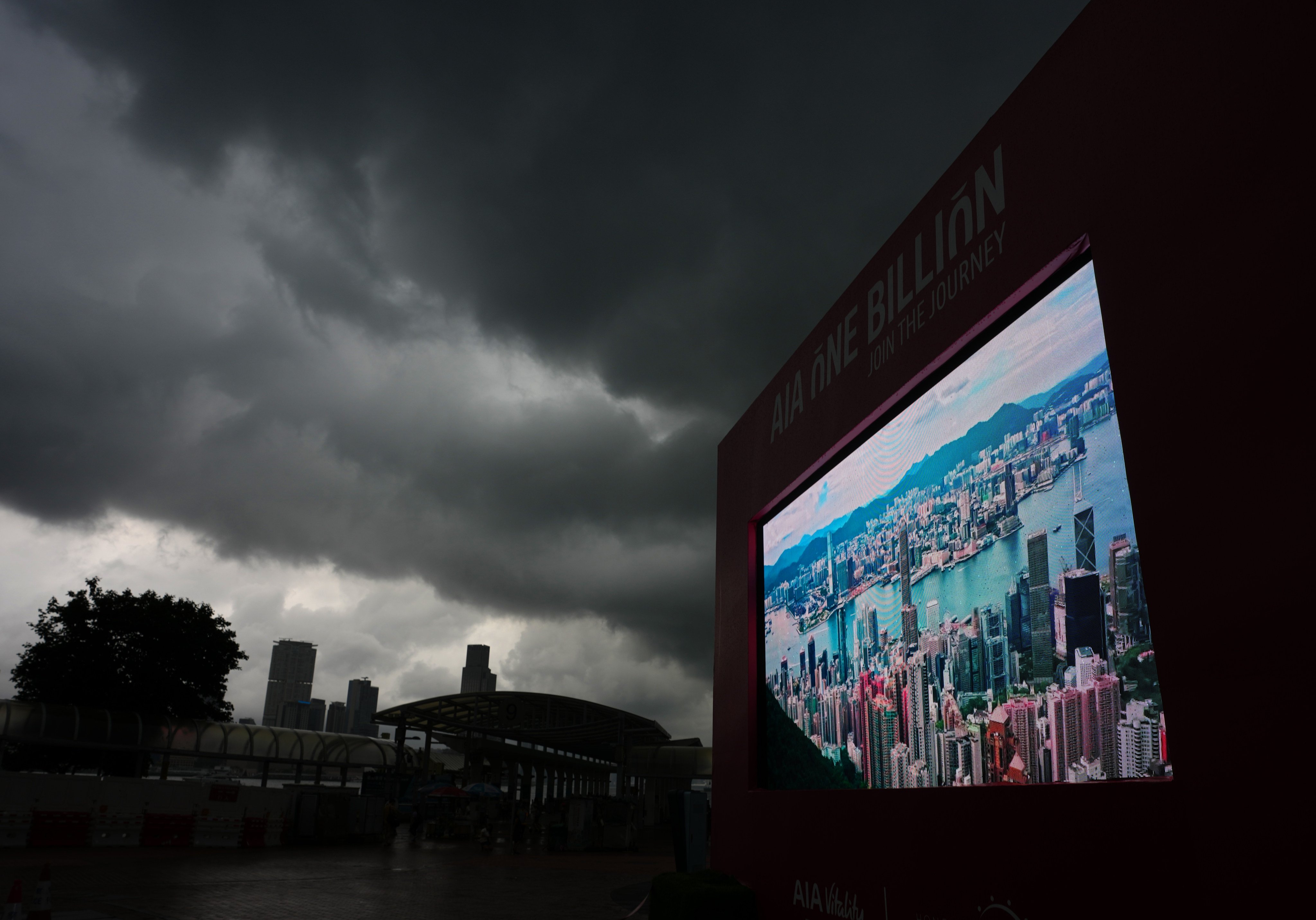 Thick clouds darken the sky at the Central Harbourfront as rain continues to lash the city. Photo: Sam Tsang
